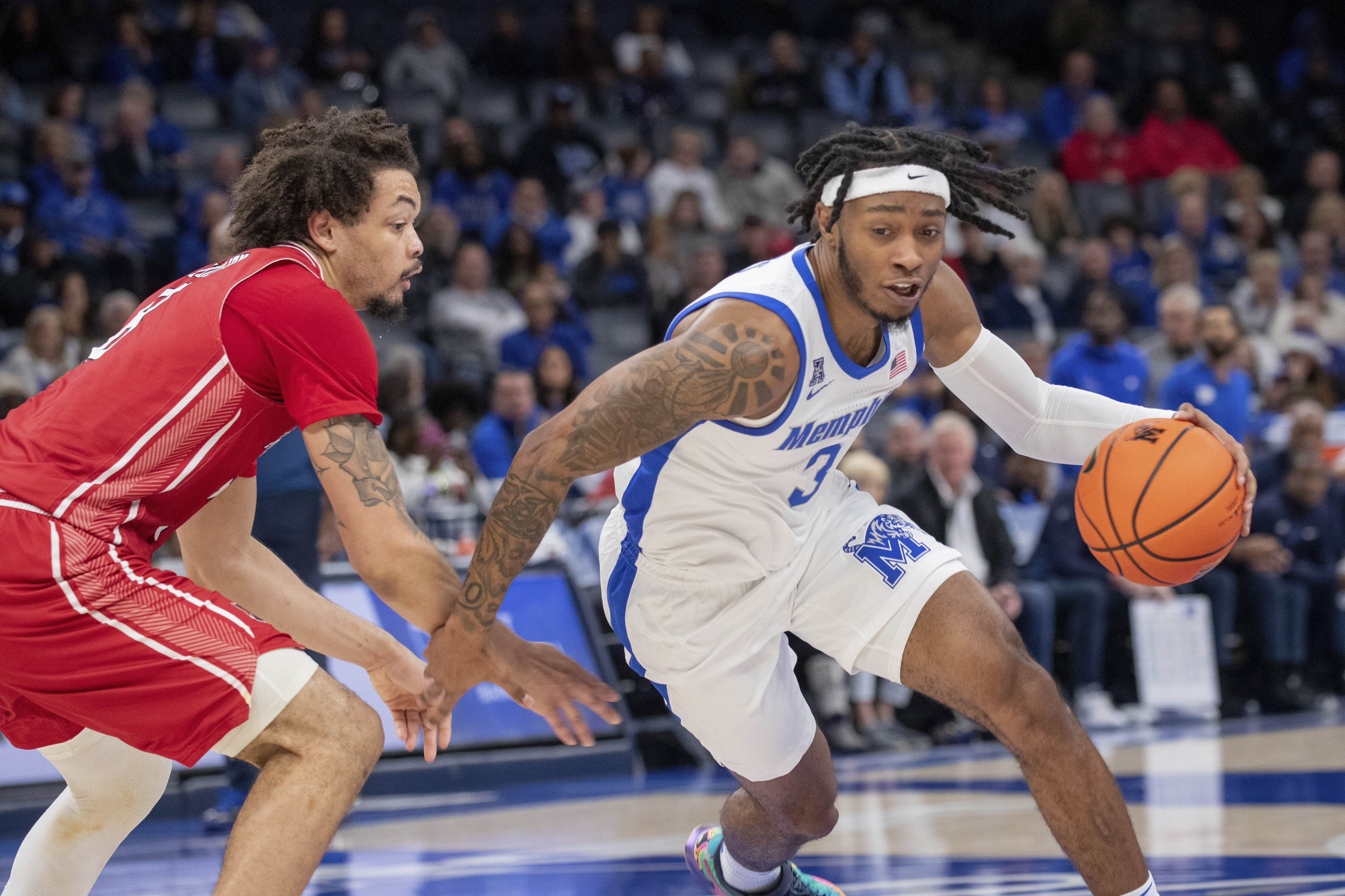 Arkansas State forward Kobe Julien, left, defends against Memphis guard Colby Rogers (3) during the first half of an NCAA college basketball game Sunday, Dec. 8, 2024, in Memphis, Tenn.