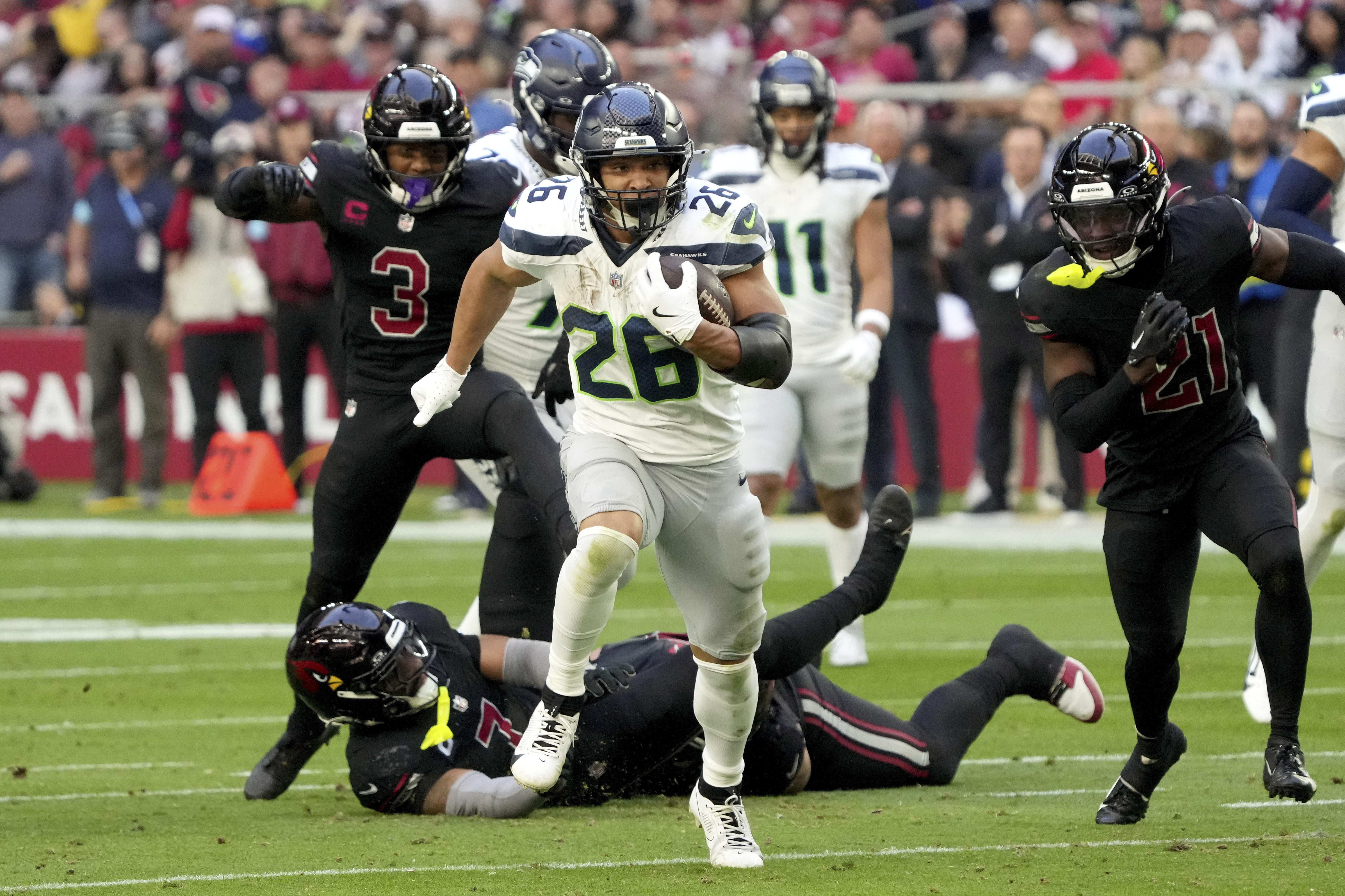 Seattle Seahawks running back Zach Charbonnet (26) runs for a touchdown against the Arizona Cardinals during the first half of an NFL football game, Sunday, Dec. 8, 2024, in Glendale, Ariz.