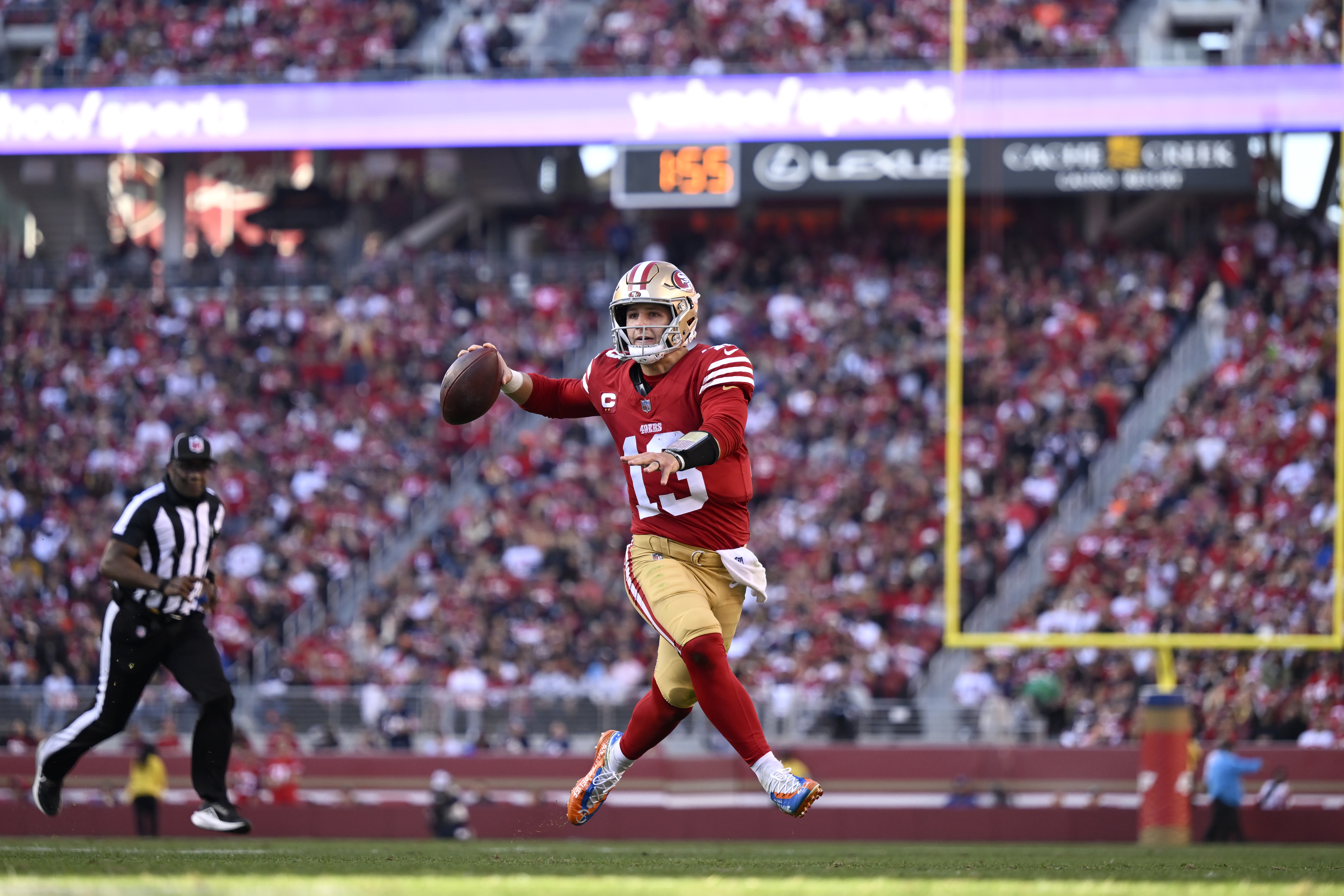 San Francisco 49ers quarterback Brock Purdy (13) rolls out to pass against the Chicago Bears during the first half of an NFL football game in Santa Clara, Calif., Sunday, Dec. 8, 2024.