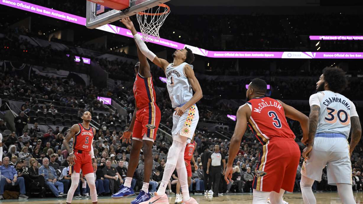 San Antonio Spurs' Victor Wembanyama (1) goes to the basket against New Orleans Pelicans' Yves Missi during the first half of an NBA basketball game, Sunday, Dec. 8, 2024, in San Antonio.