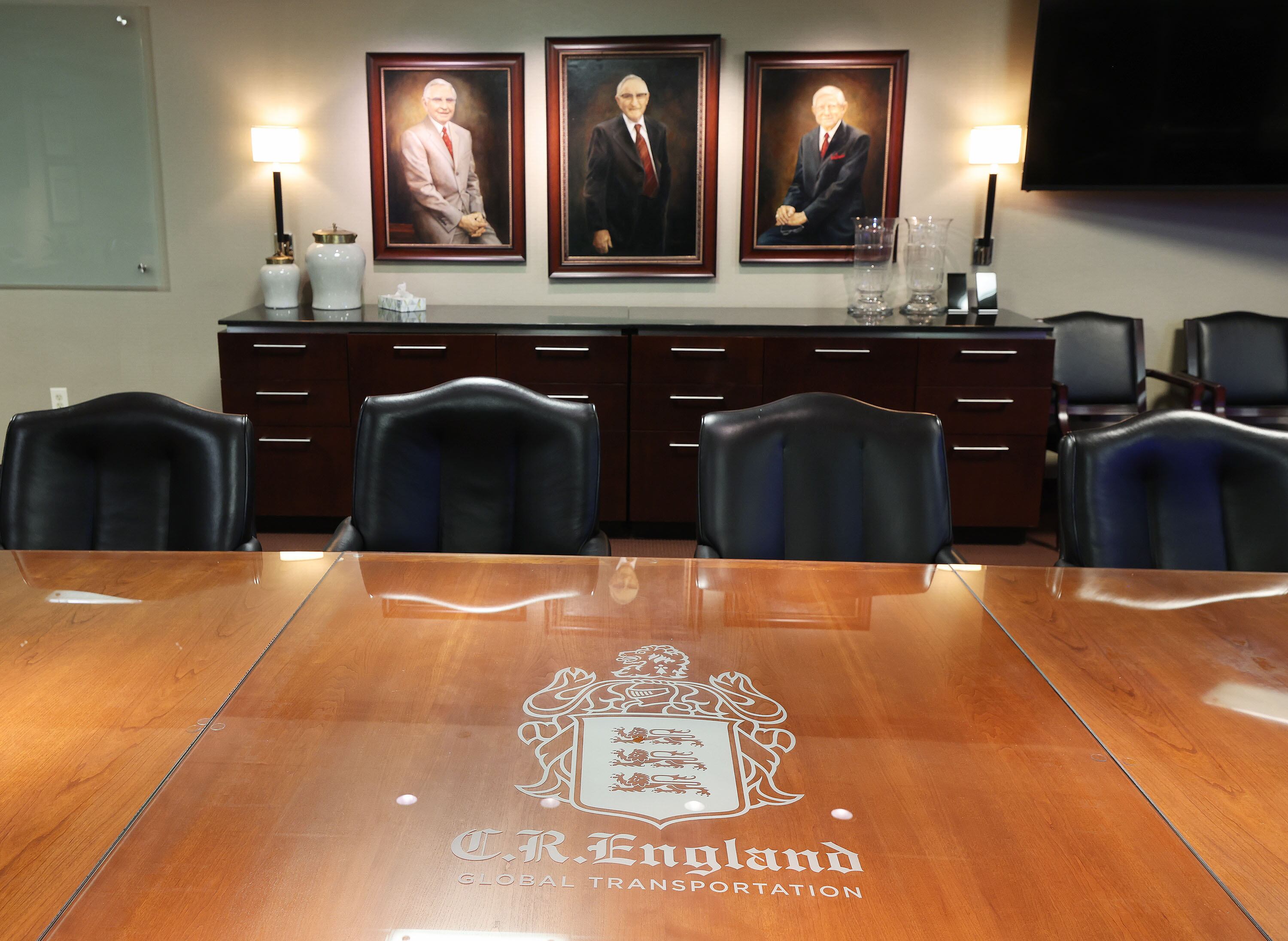 England family photos hang in the boardroom of C.R. England in West Valley City on Wednesday, Nov. 20, 2024. Recently, 105-year-old Gene England died, but regularly came to the office before his death.