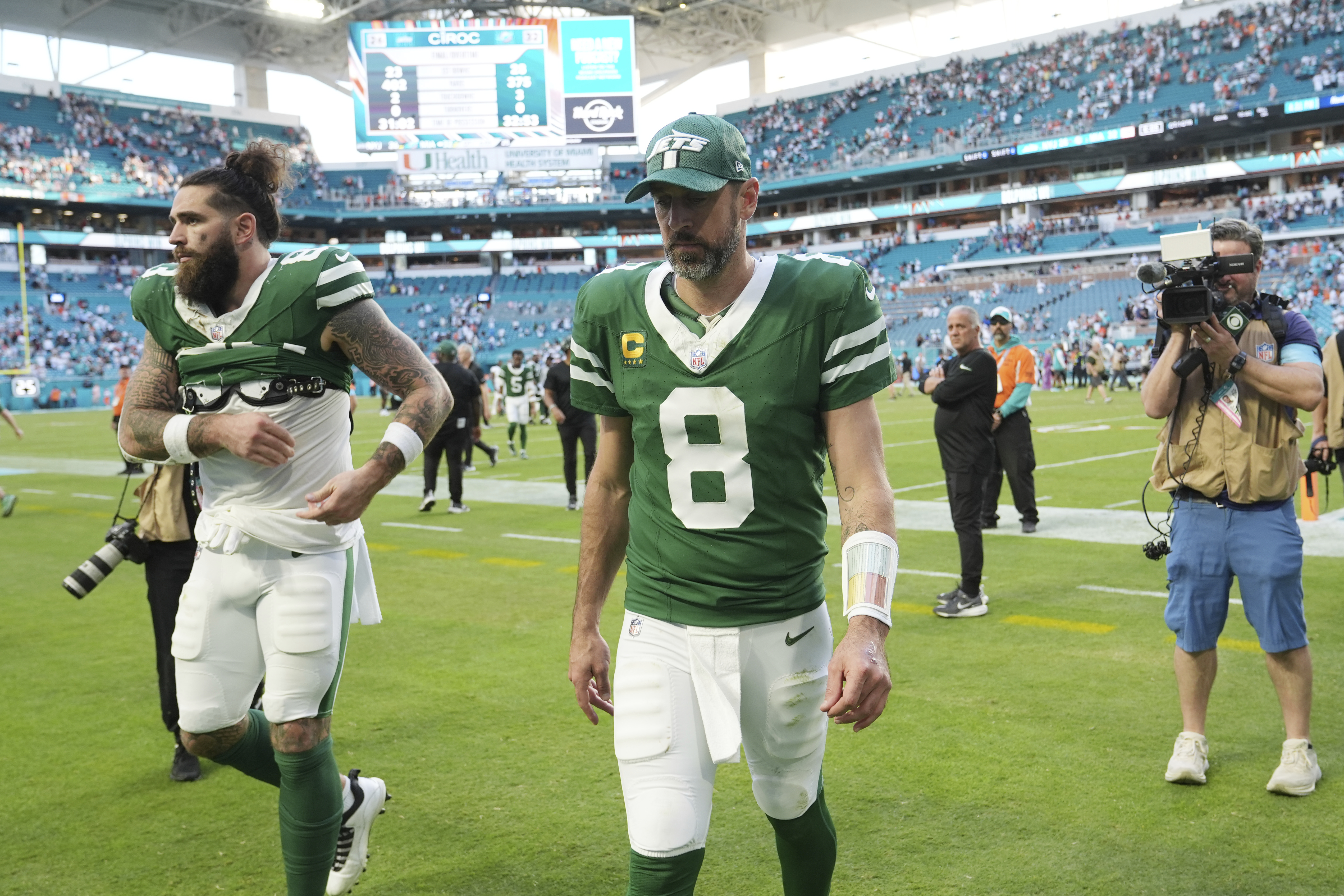 New York Jets quarterback Aaron Rodgers (8) leaves the field at the end of an NFL football game against the Miami Dolphins, Sunday, Dec. 8, 2024, in Miami Gardens, Fla.
