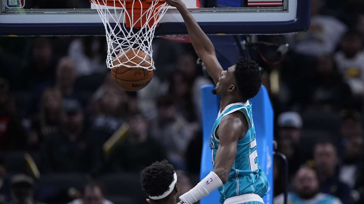 Charlotte Hornets' Brandon Miller dunks against Indiana Pacers' Pascal Siakam (43) during the second half of an NBA basketball game, Sunday, Dec. 8, 2024, in Indianapolis.