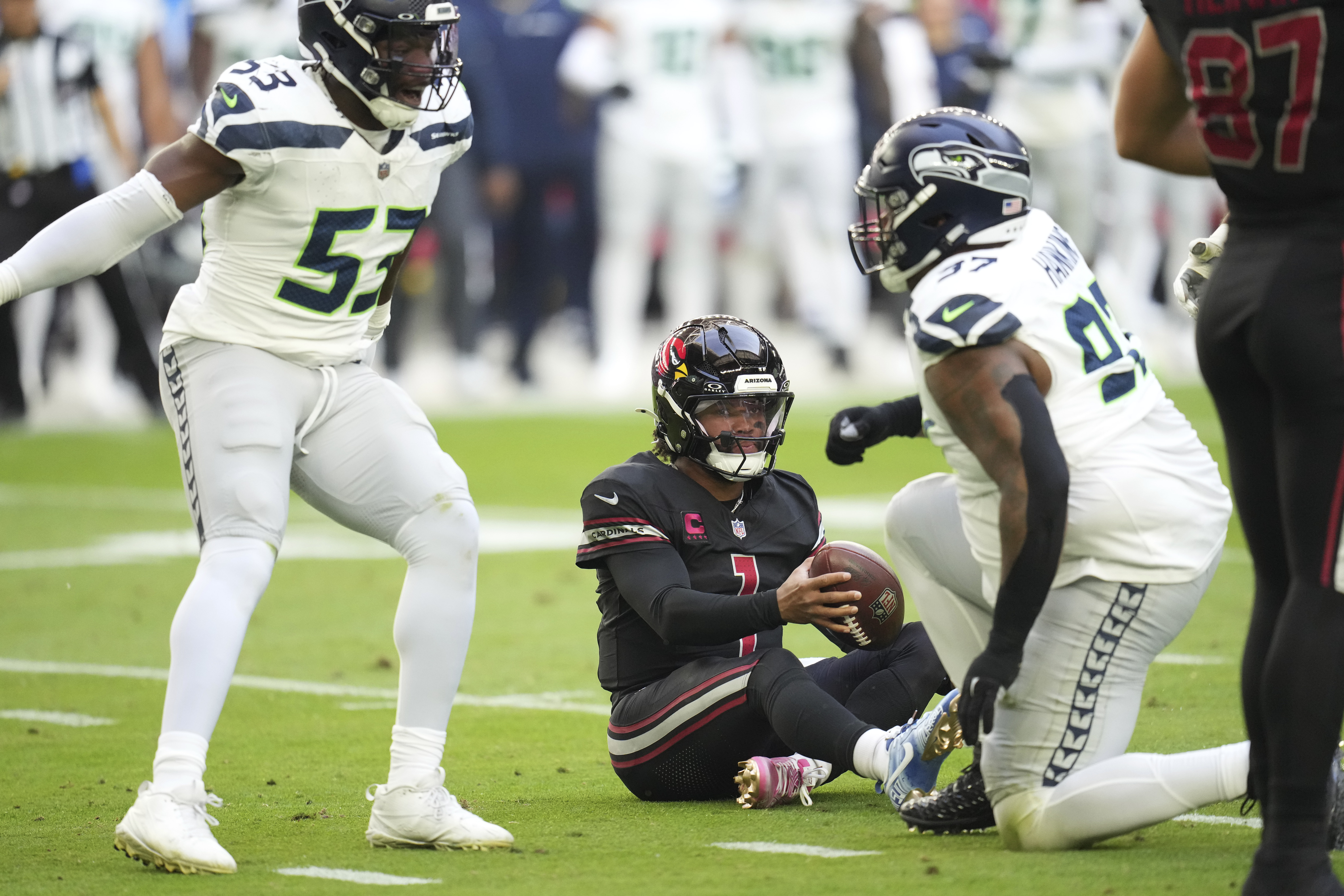 Seattle Seahawks defensive tackle Johnathan Hankins, right, and linebacker Boye Mafe (53) celebrate after sacking Arizona Cardinals quarterback Kyler Murray (1) during the first half of an NFL football game, Sunday, Dec. 8, 2024, in Glendale, Ariz.