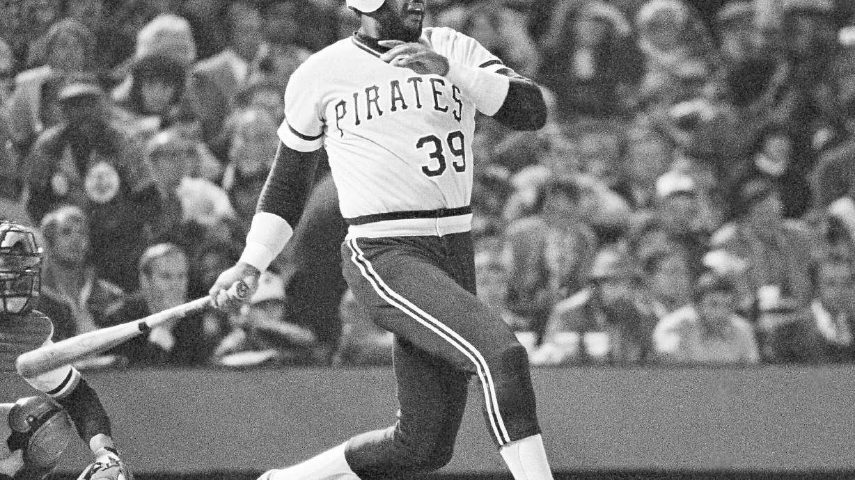 FILE - Pirates Dave Parker smashes ball that took a bad hop in front of Orioles Rich Dauer and sailed into right field scoring Omar Moreno and the Bucs first run in the seventh inning of the sixth World Series game, Oct. 16, 1979, in Baltimore. Parker was credited with a single. Tim Foli, who later scored, took third.