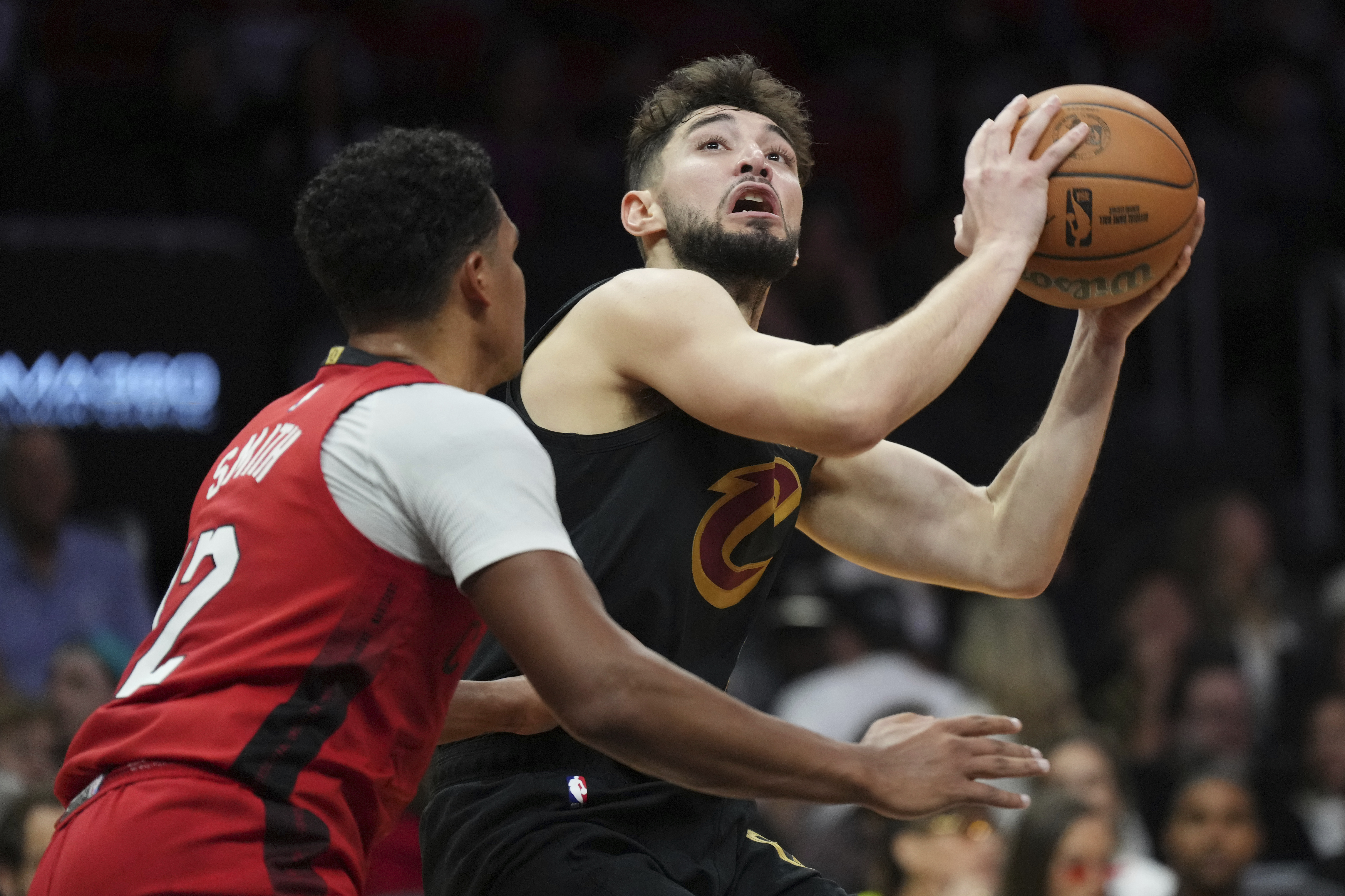 Cleveland Cavaliers guard Ty Jerome, right, takes a shot over Miami Heat guard Dru Smith during the second half of an NBA basketball game, Sunday, Dec. 8, 2024, in Miami.
