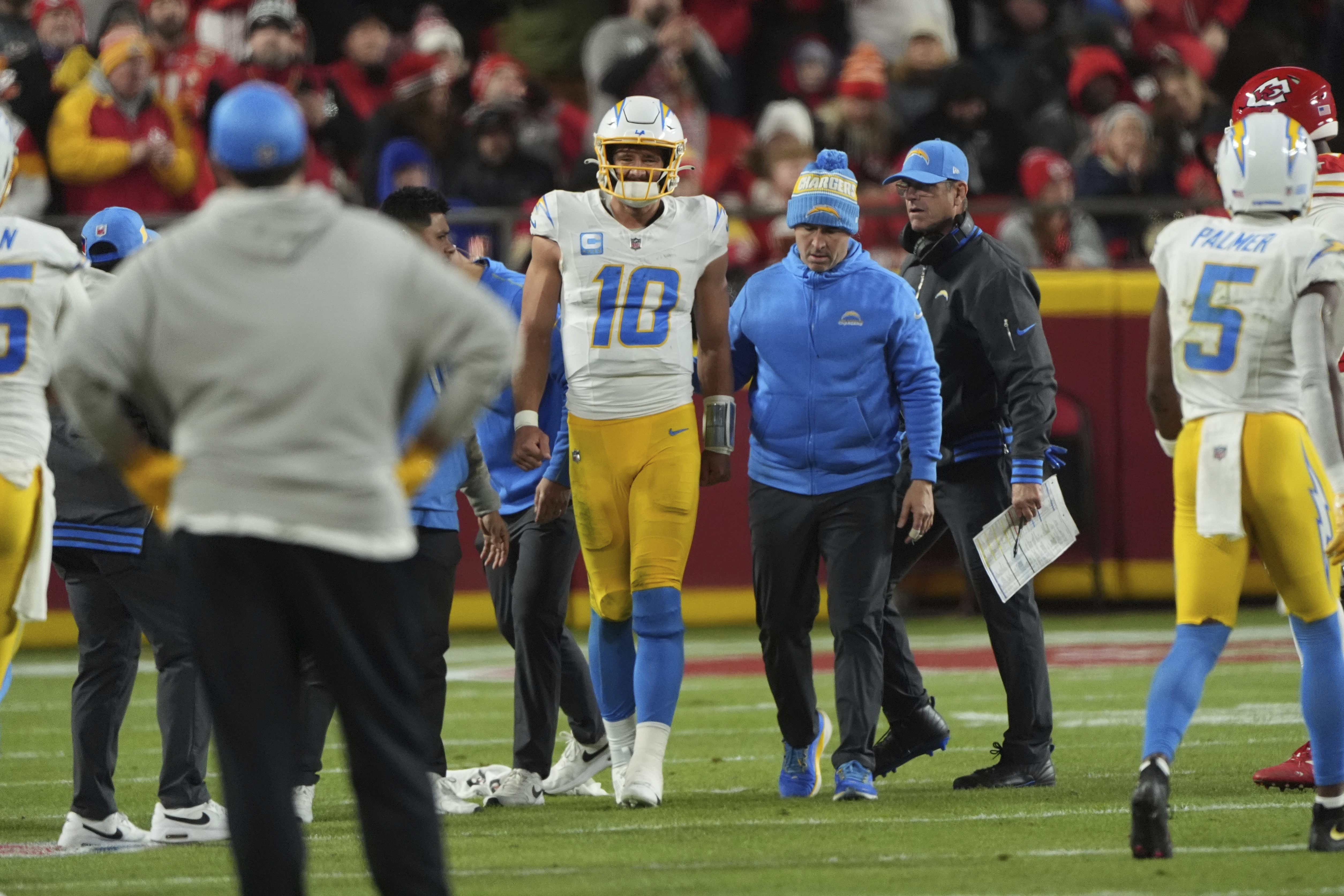 Los Angeles Chargers quarterback Justin Herbert (10) walks off the field after being injured during the first half of an NFL football game against the Kansas City Chiefs Sunday, Dec. 8, 2024, in Kansas City, Mo.