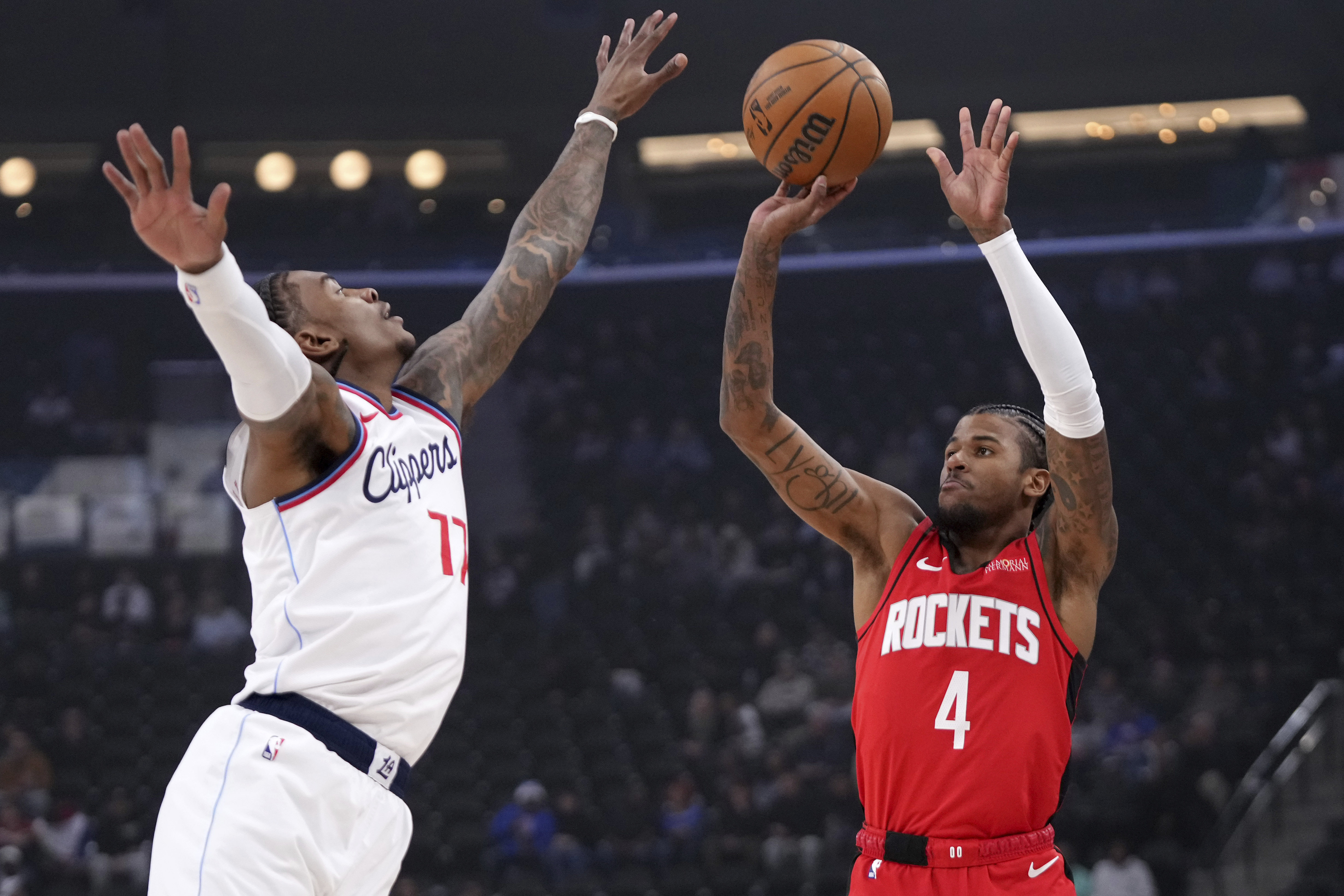 Houston Rockets guard Jalen Green, right, shoots as Los Angeles Clippers guard Kevin Porter Jr. defends during the first half of an NBA basketball game, Sunday, Dec. 8, 2024, in Inglewood, Calif.