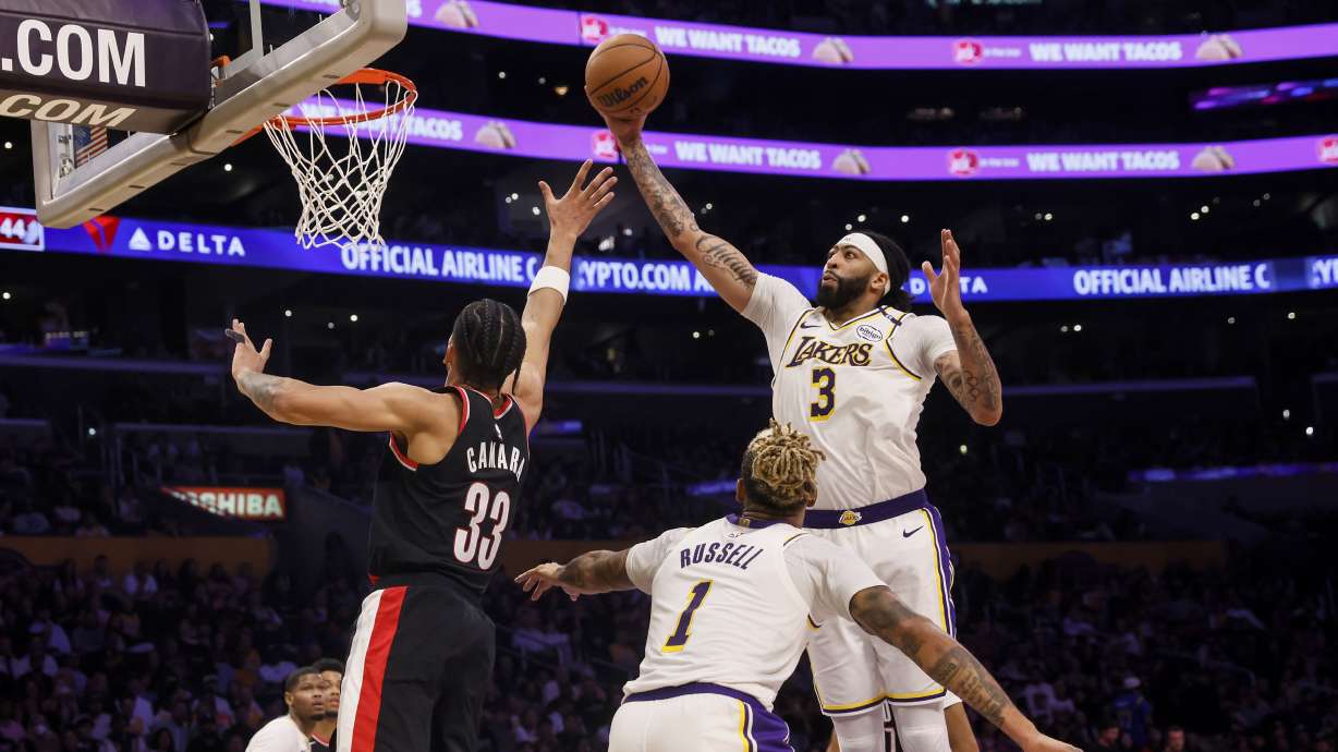 Los Angeles Lakers forward/center Anthony Davis, right, catches a rebound against Portland Trail Blazers' forward Toumani Camara during the second half of an NBA basketball game, Sunday, Dec. 8, 2024, in Los Angeles.