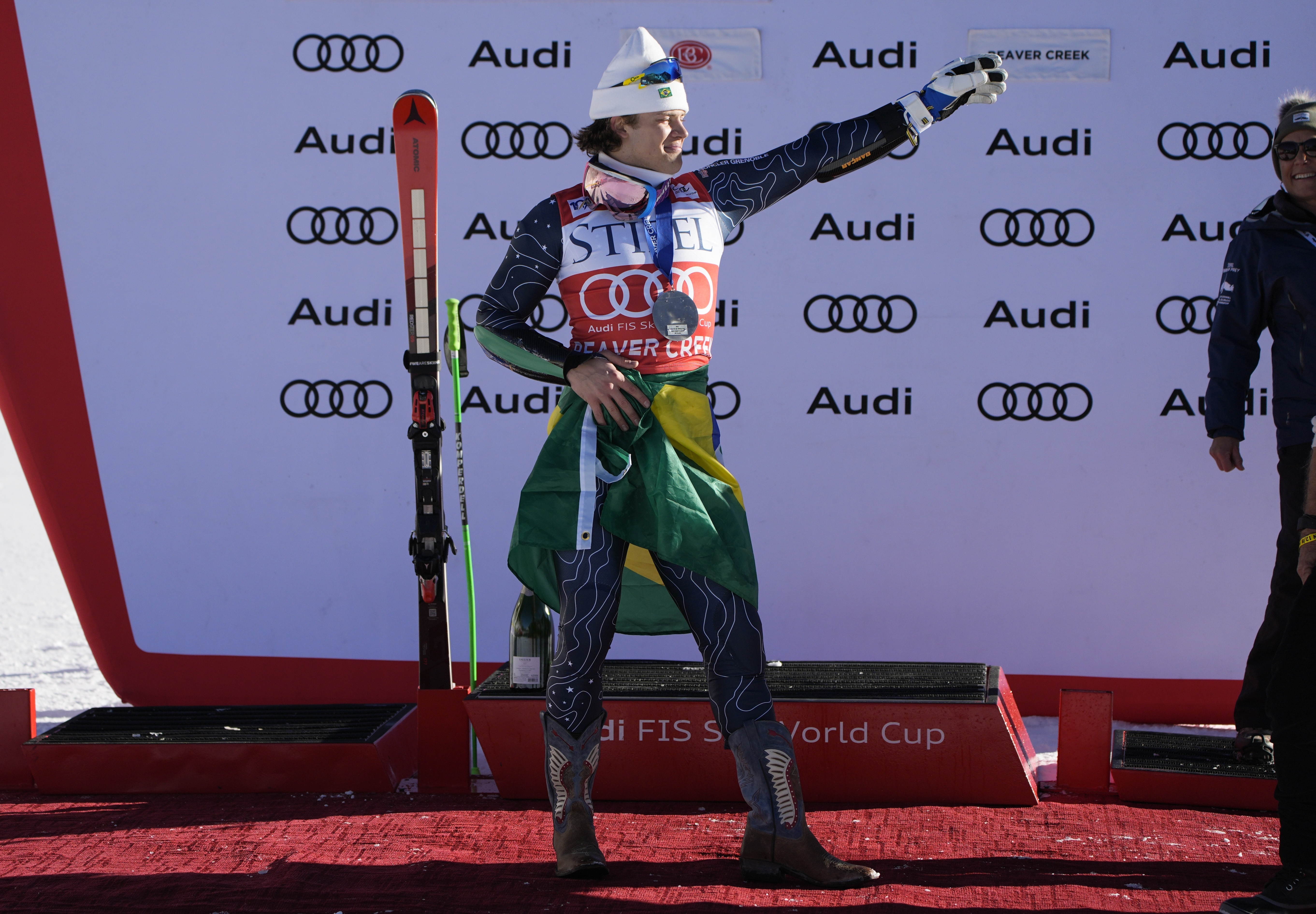 Second place finisher Brazil's Lucas Pinheiro Braathen celebrates with a Brazilian flag tied around his waist after a men's World Cup giant slalom skiing race, Sunday, Dec. 8, 2024, in Beaver Creek.