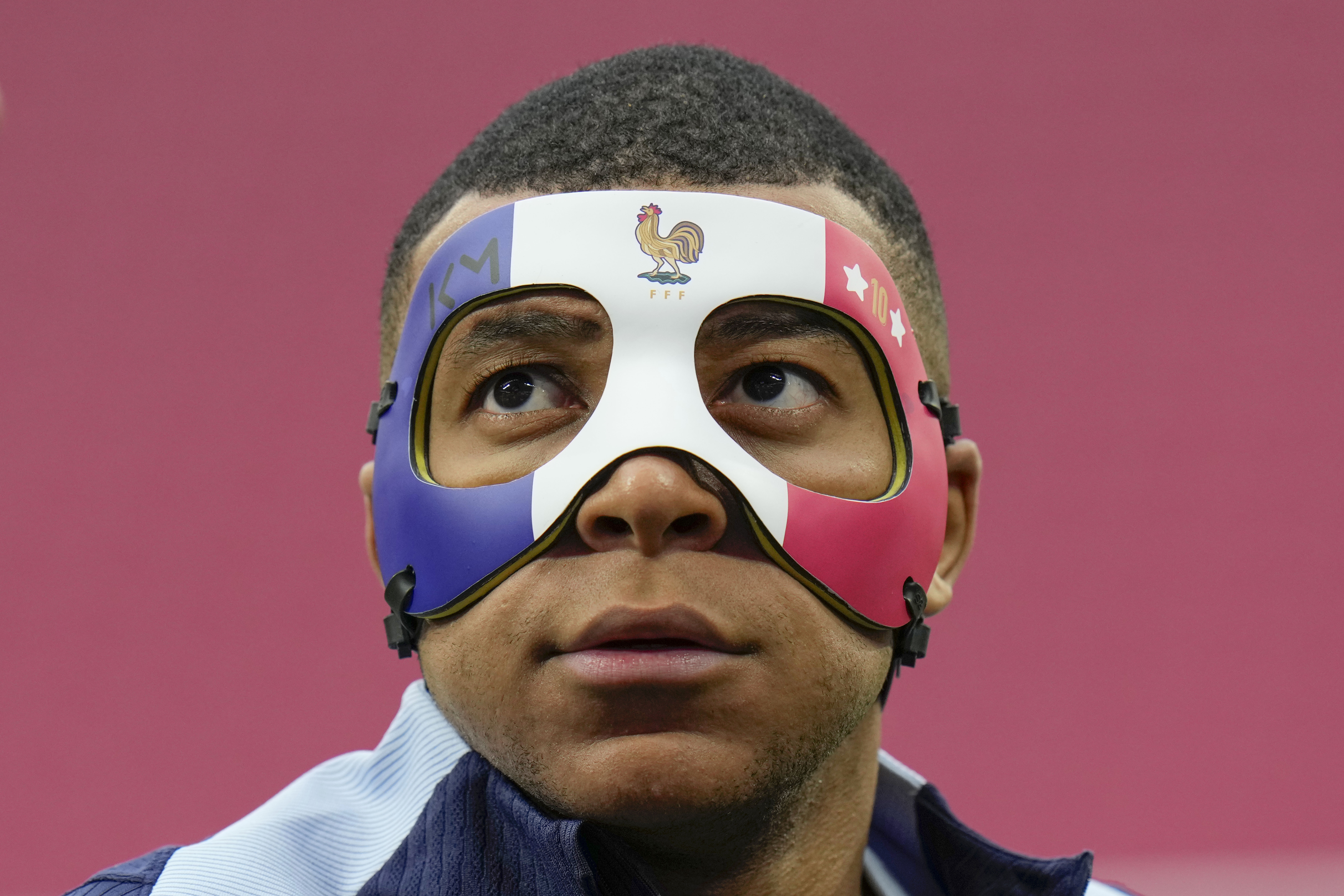 FILE - France's Kylian Mbappe looks up as he wears a face mask during a team training session in Leipzig, Germany, Thursday, June 20, 2024.