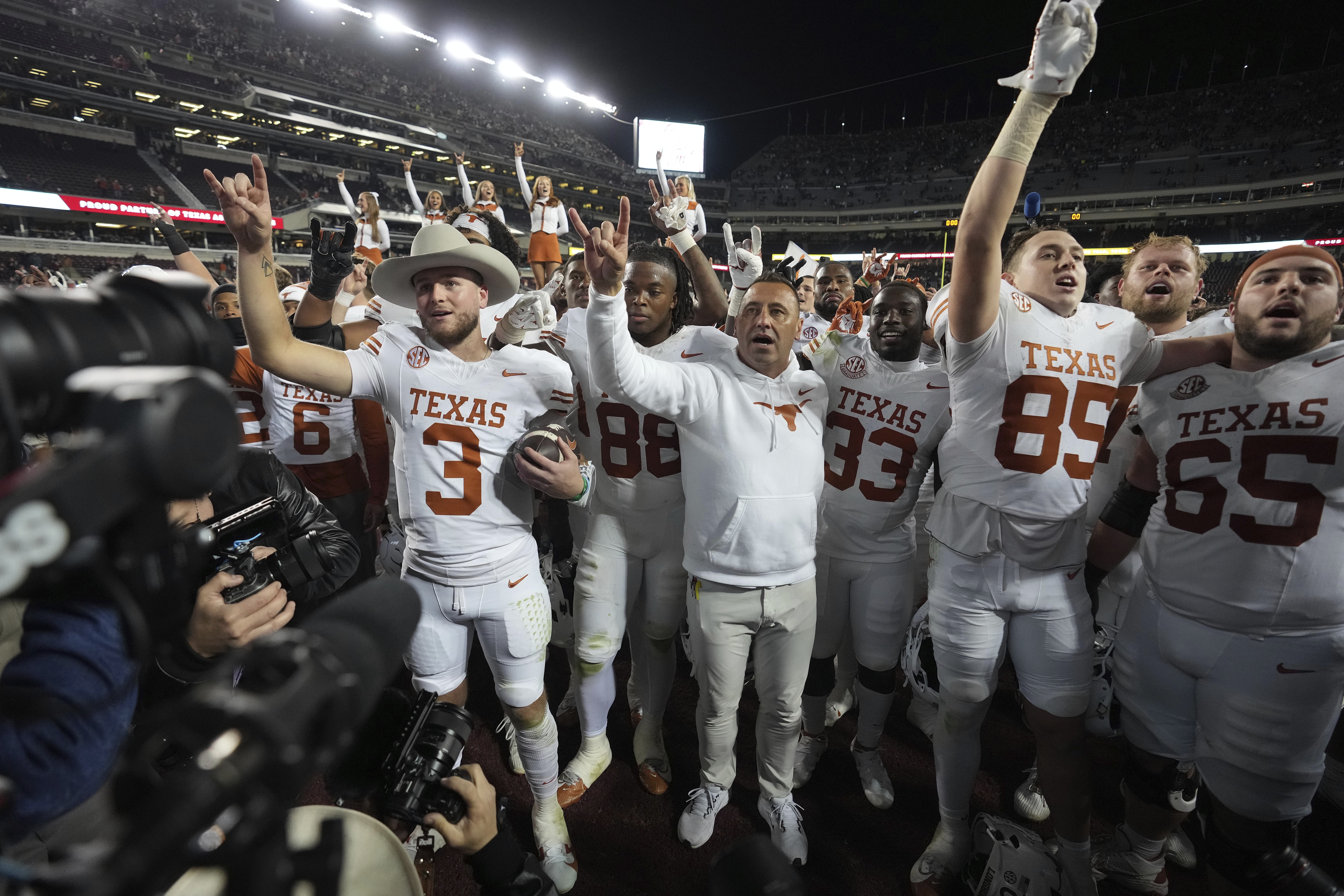 Texas head coach Steve Sarkisian, center, along with quarterback Quinn Ewers, left, and the rest of the Longhorns, after beating Texas A&M in an NCAA college football game, Saturday, Nov. 30, 2024, in College Station, Texas.