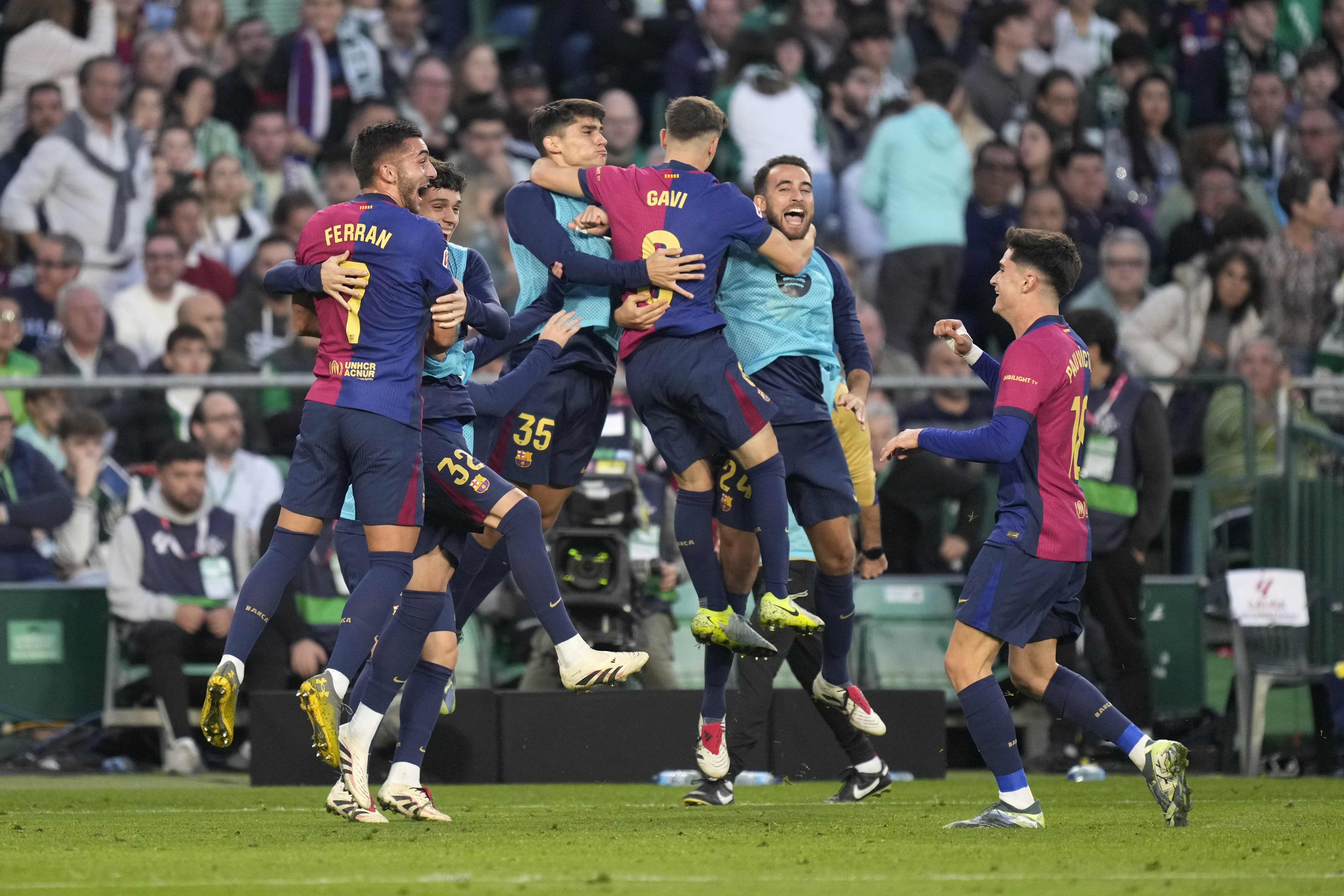 Barcelona players celebrate after Barcelona's Ferran Torres scored his side's second goal during a Spanish La Liga soccer match between Betis and Barcelona at the Benito Villamarin stadium in Seville, Spain, Saturday, Dec. 7, 2024.