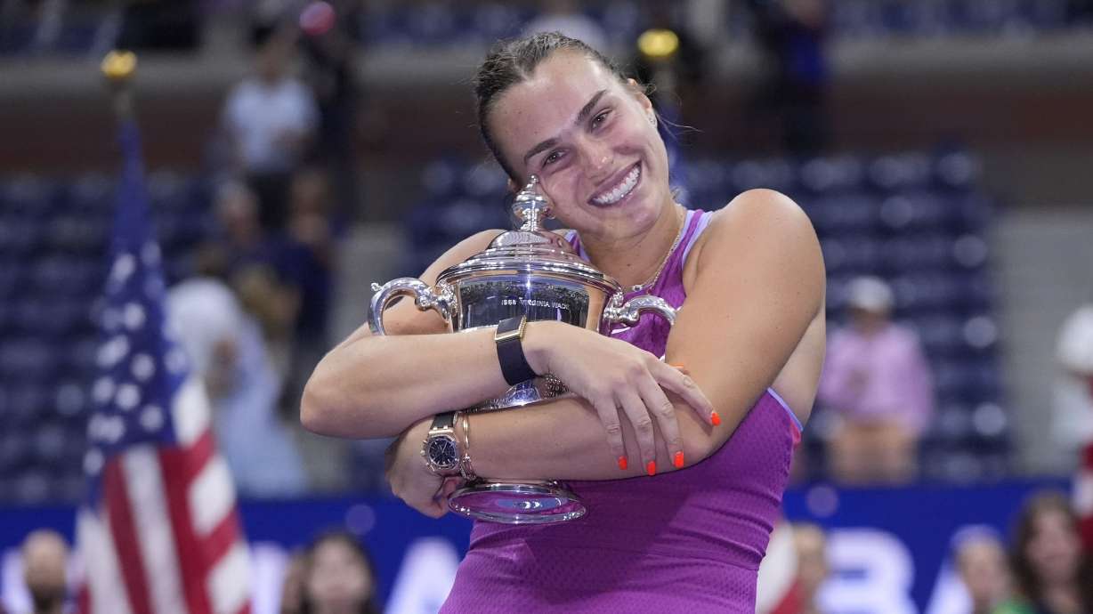 FILE - Aryna Sabalenka, of Belarus, hugs the trophy after winning the women's singles final of the U.S. Open tennis championships against Jessica Pegula, of the United States, on Sept. 7, 2024, in New York.