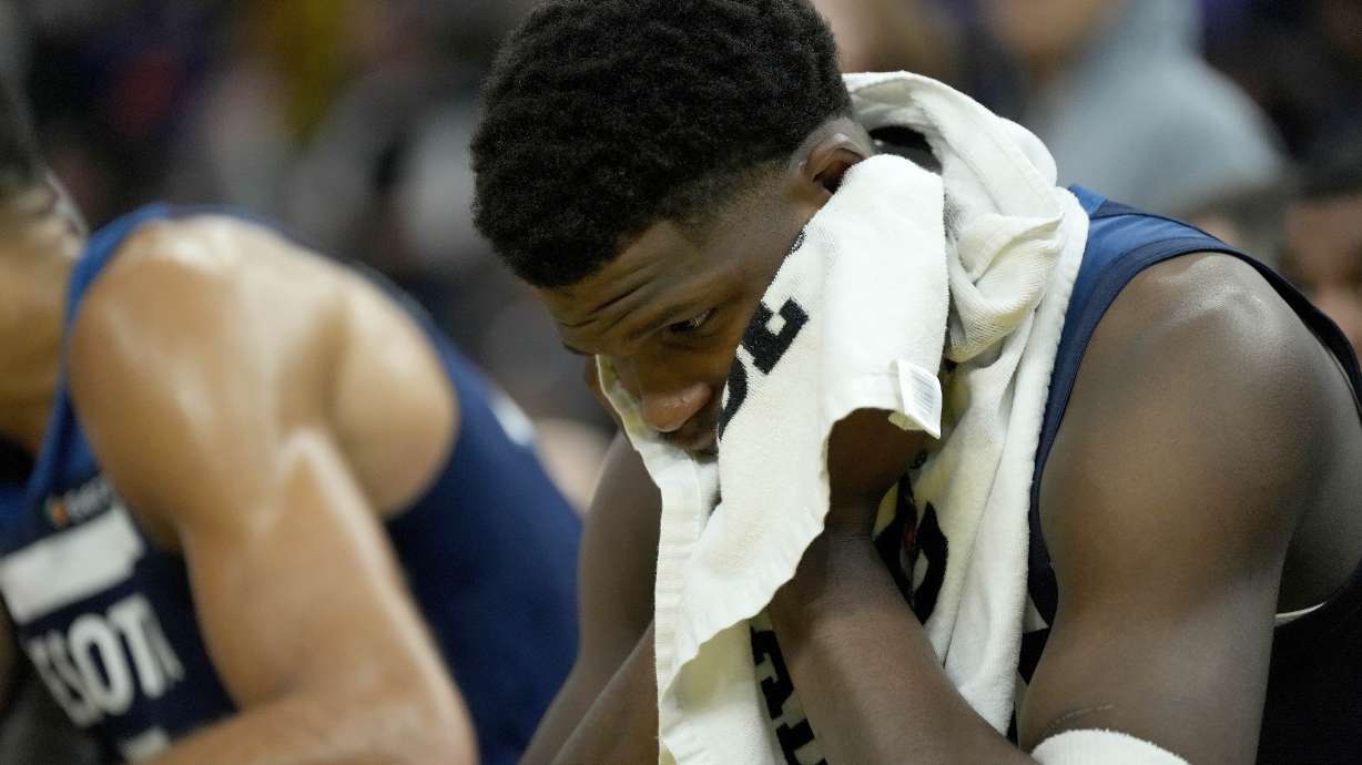 Minnesota Timberwolves guard Anthony Edwards covers his face with a towel during a timeout in the second half of an NBA basketball game against the Golden State Warriors in San Francisco, Sunday Dec. 8, 2024.