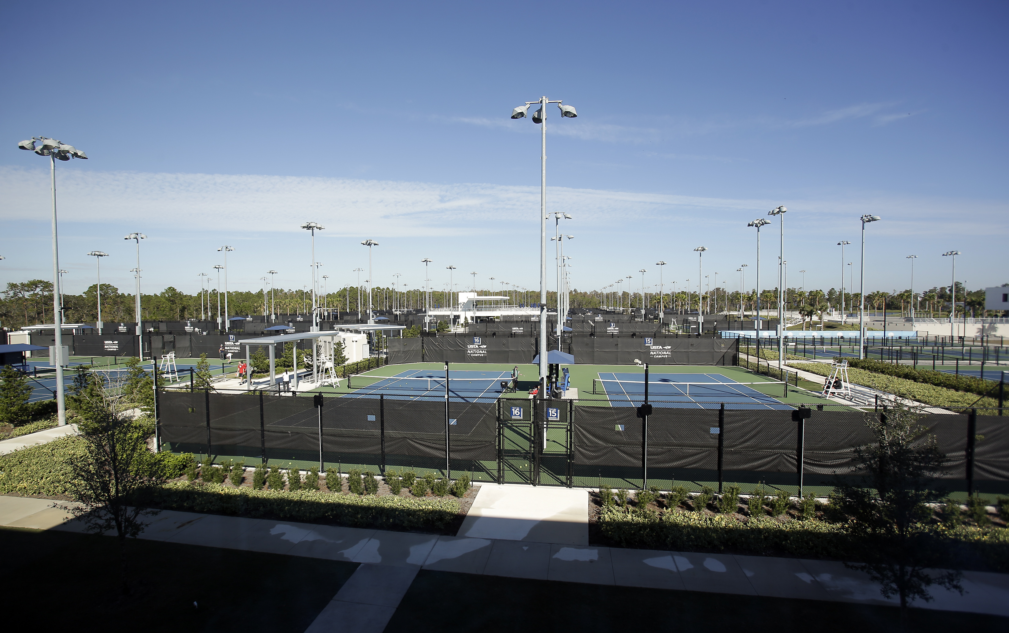 FILE - In this Dec. 12, 2017, photo, some of the 100 tennis courts that are available to players are seen at the USTA National Campus in Orlando, Fla.
