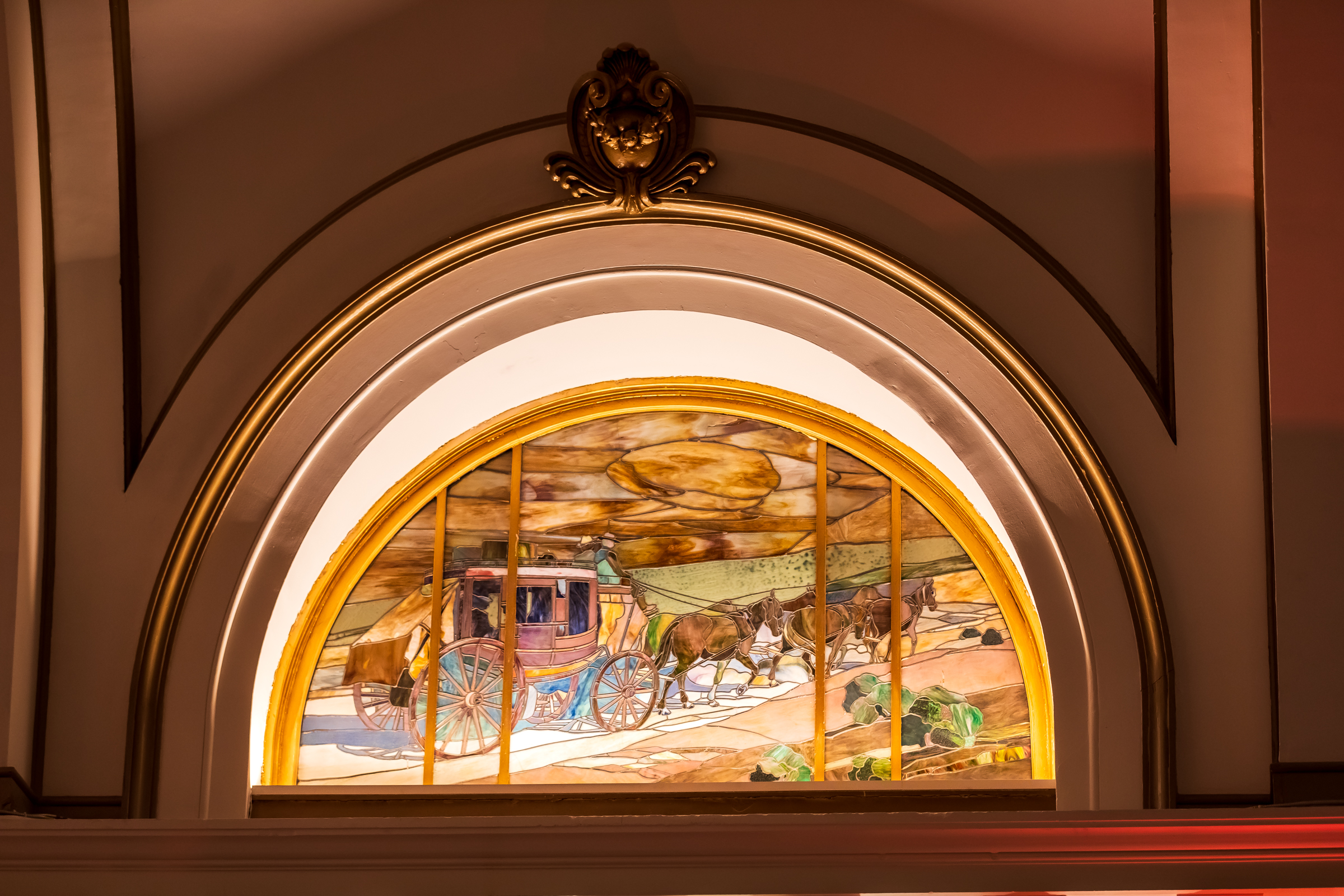 A stained glass window depicting horses and a carriage is pictured inside the Union Pacific Railroad Station on Thursday. The windows were originally installed in 1909.