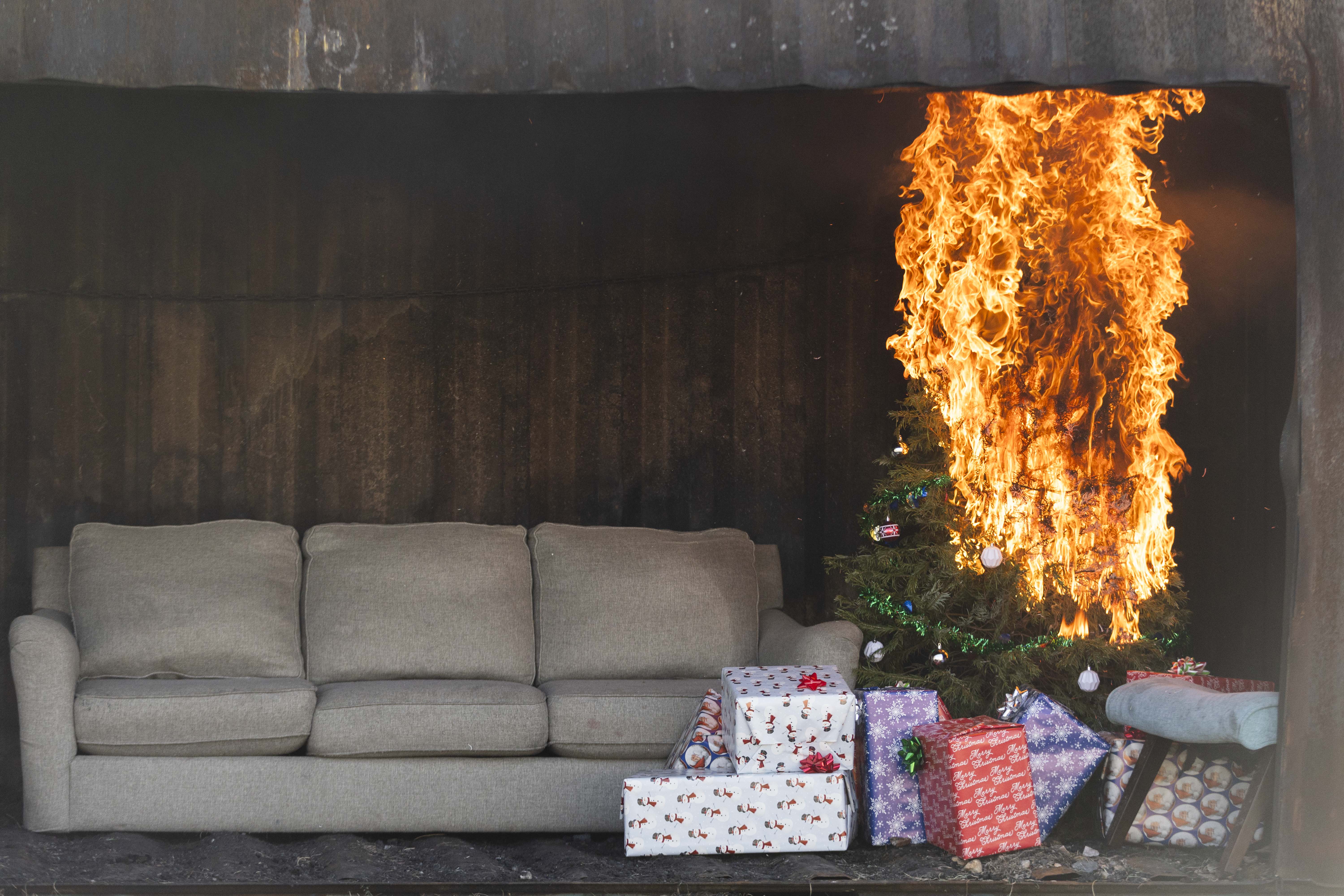 A mock living room with a Christmas tree, presents and a couch burns during a Christmas tree fire safety demonstration held by the American Red Cross of Utah and Salt Lake City Fire Department at the Salt Lake City Fire Training Center ion Monday.