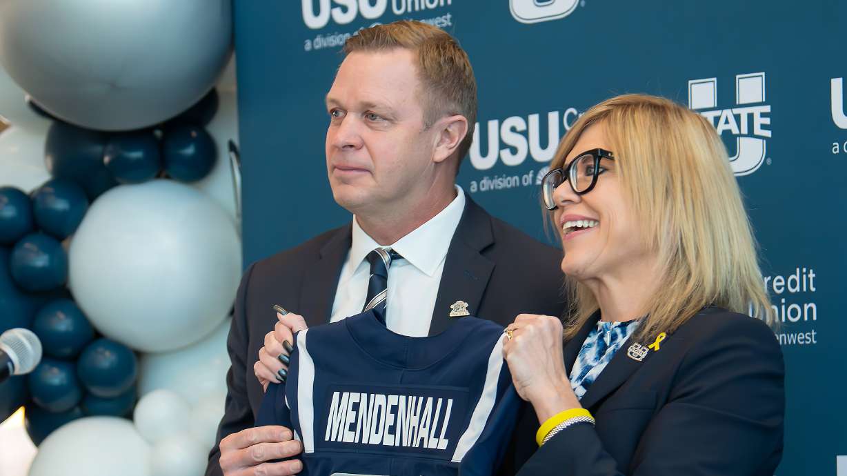 Bronco Mendenhall, left, and Athletics Director Diana Sabau attend a press conference where Mendenhall was introduced as the new football coach at Utah State University, Monday Dec. 9, 2024, in Logan, Utah.