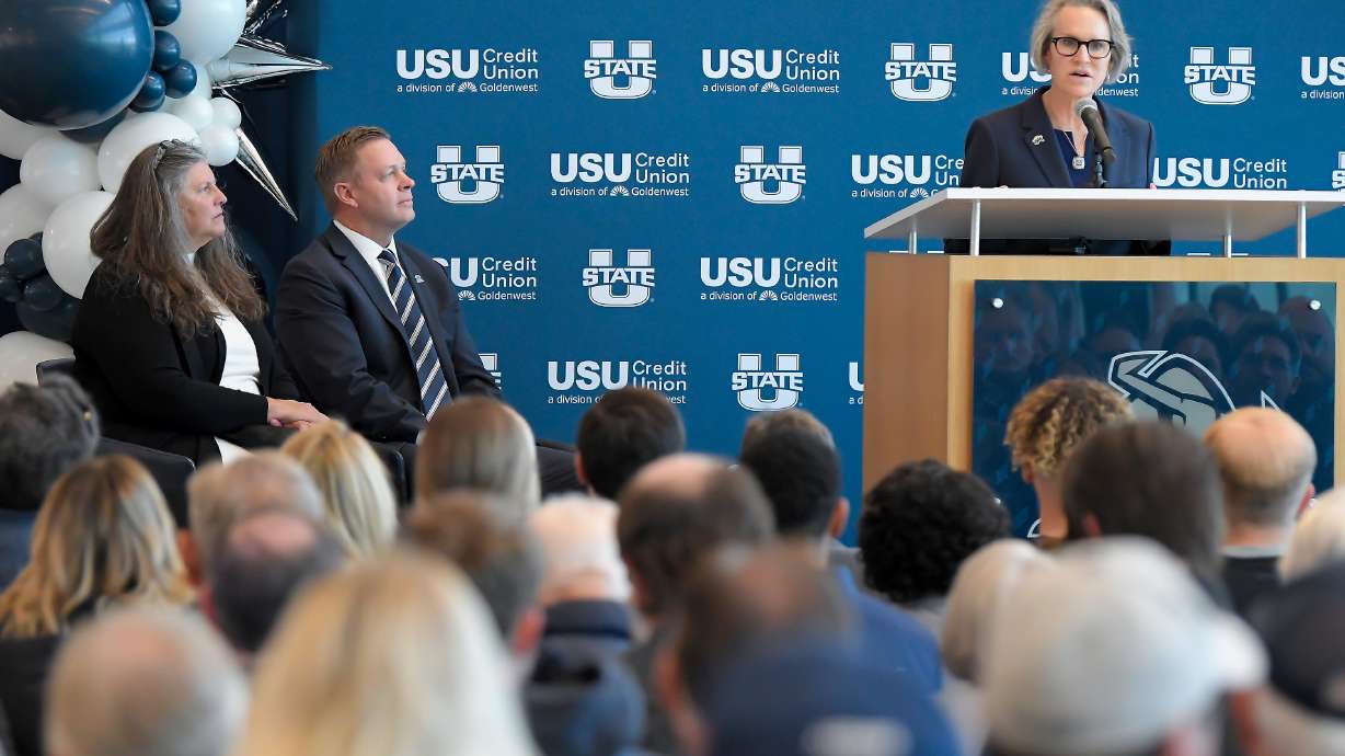 Holly and Bronco Mendenhall listen as Utah State President Elizabeth Cantwell speaks at a press conference where Bronco was introduced as the new football coach at Utah State University, Monday Dec. 9, 2024, in Logan, Utah.