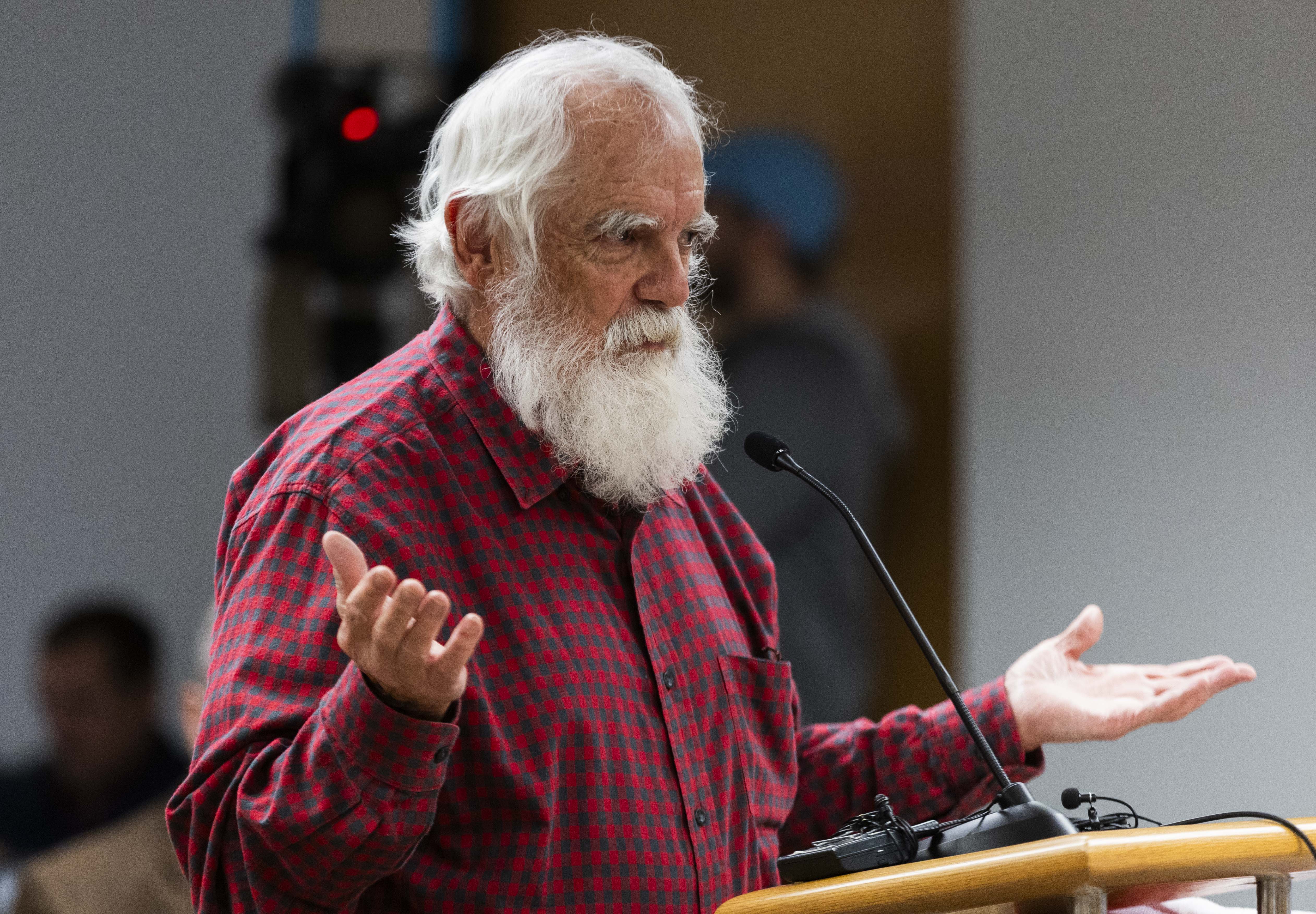 Salt Lake City resident Tim Funk puts his hands up while questioning proposed rate hikes by Rocky Mountain Power at a Utah Public Service Commission’s public hearing in the Heber Wells Building in Salt Lake City on Monday.