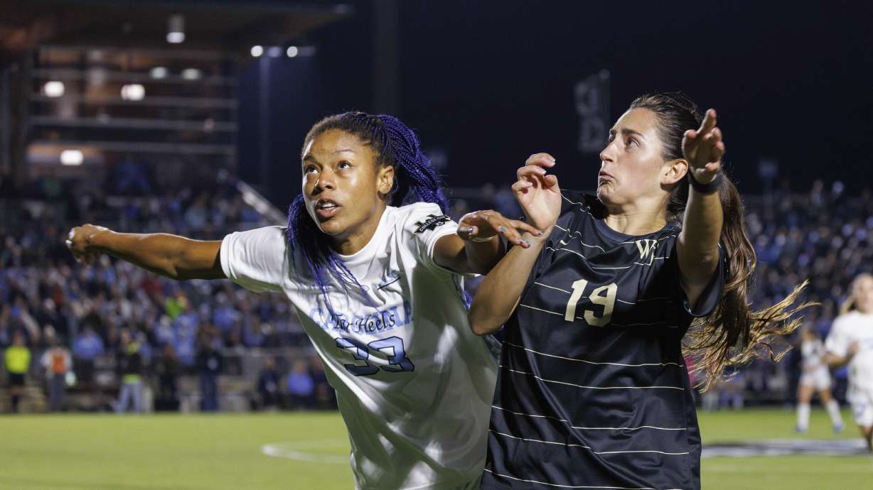 North Carolina's Olivia Thomas and Wake Forest's Sierra Sythe (19) battle for a ball during the first half of NCAA Women's College Cup soccer final in Cary, N.C., Monday, Dec. 9, 2024.
