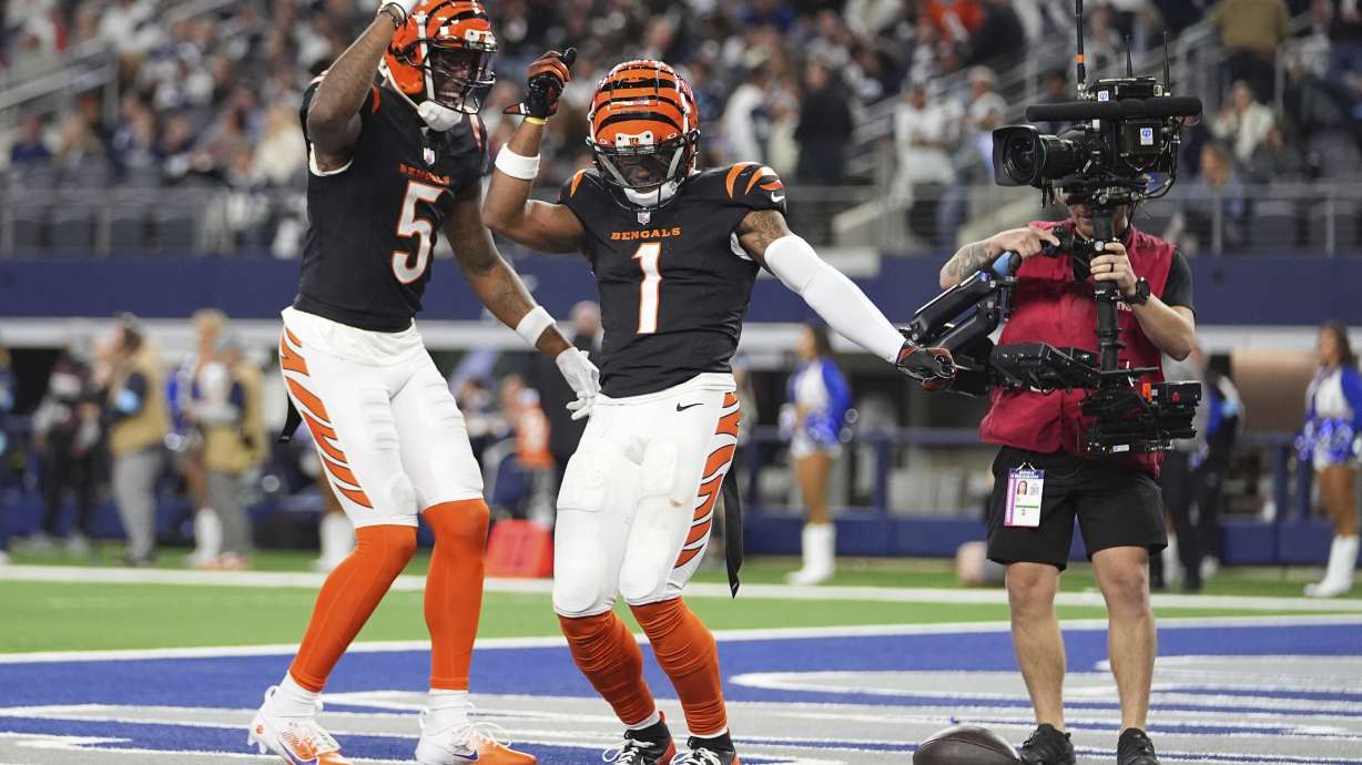 Cincinnati Bengals wide receiver Ja'Marr Chase (1) celebrates his touchdown with wide receiver Tee Higgins (5) during the second half of an NFL football game against the Dallas Cowboys, Monday, Dec. 9, 2024, in Arlington, Texas. The Cincinnati Bengals won 27-20.
