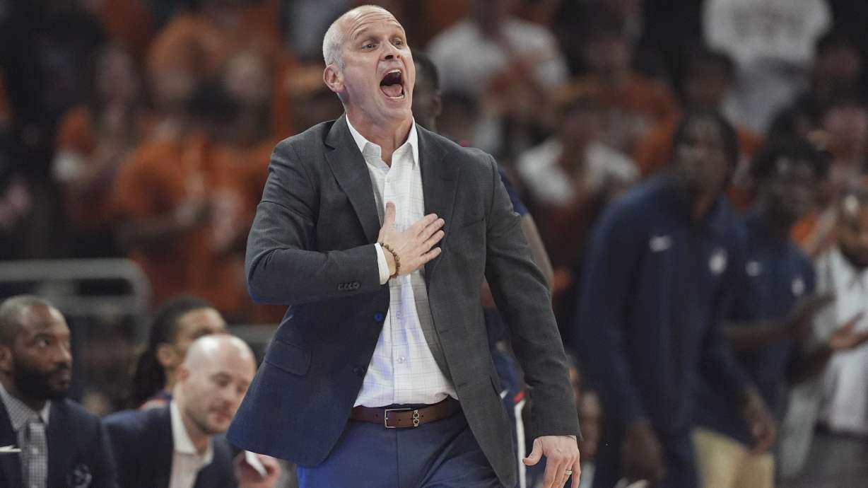 UConn head coach Dan Hurley talks to his players during the first half of an NCAA college basketball game against Texas in Austin, Texas, Sunday, Dec. 8, 2024.