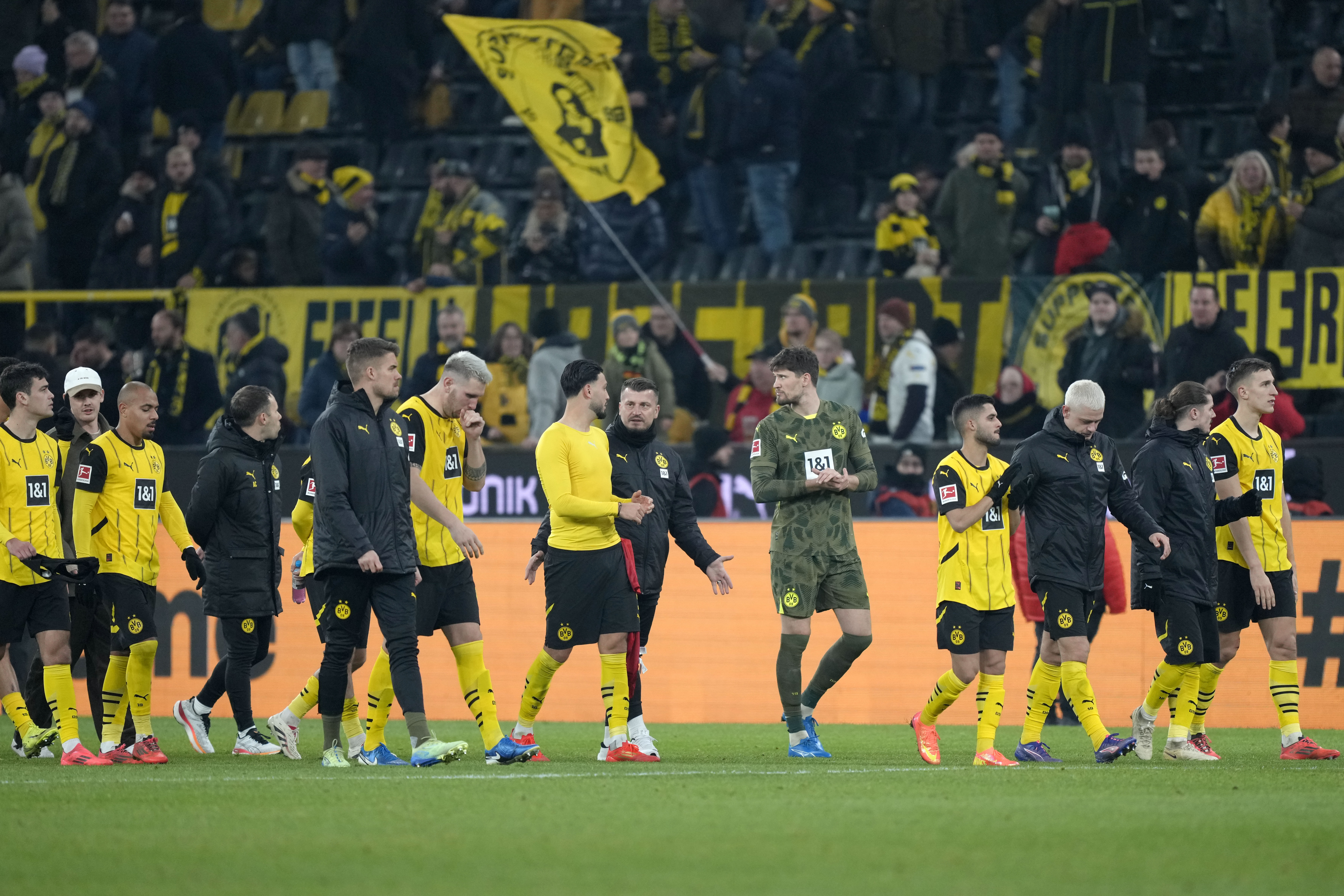 Dortmund'splayers leave the pitch after the German Bundesliga soccer match between Borussia Dortmund and Bayern Munich at the Signal-Iduna Park in Dortmund, Germany, Saturday, Nov. 30, 2024.