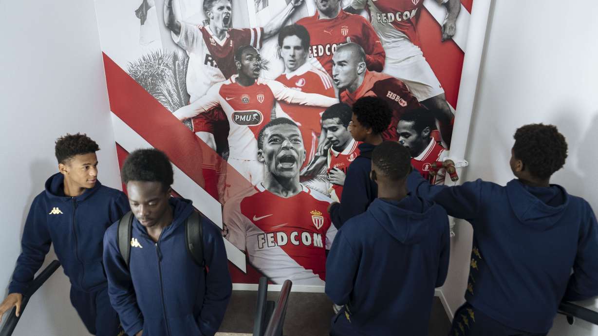 Trainees walk past a wall displaying the club's famous players in the AS Monaco academy in Cap d'Ail near Monaco, Wednesday, Dec. 4, 2024.