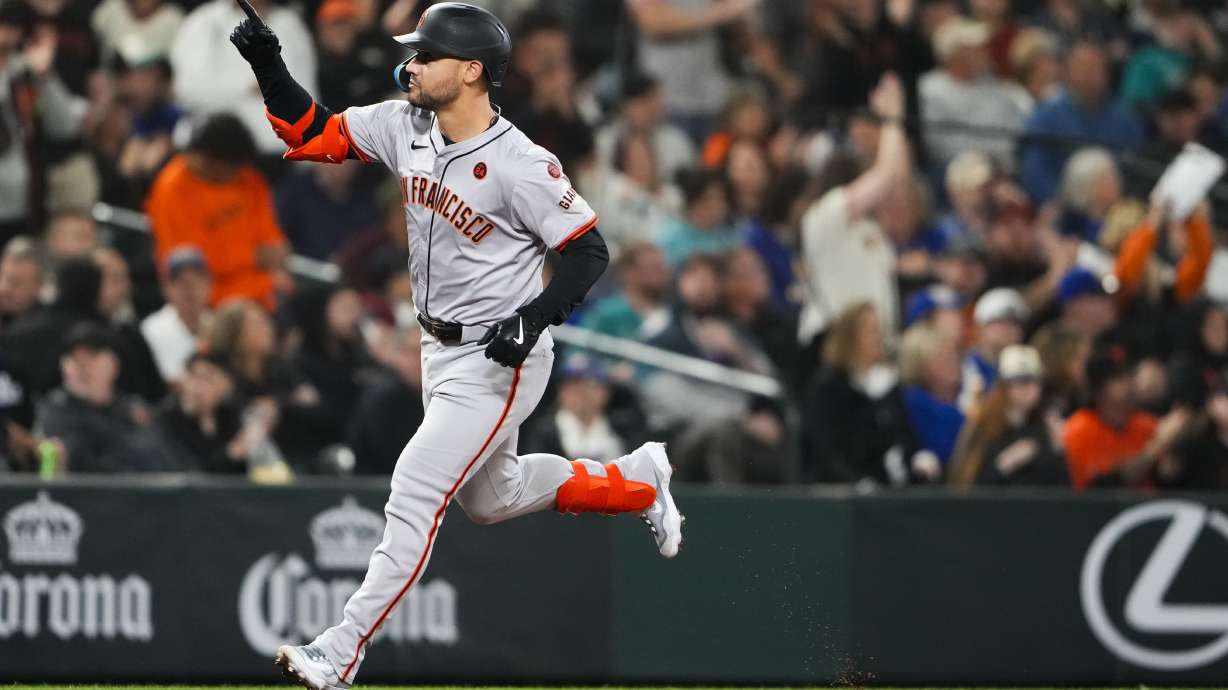 FILE - San Francisco Giants' Michael Conforto runs the bases after hitting a two-run home run to score Heliot Ramos against the Seattle Mariners during the fourth inning of a baseball game, Aug. 23, 2024, in Seattle.