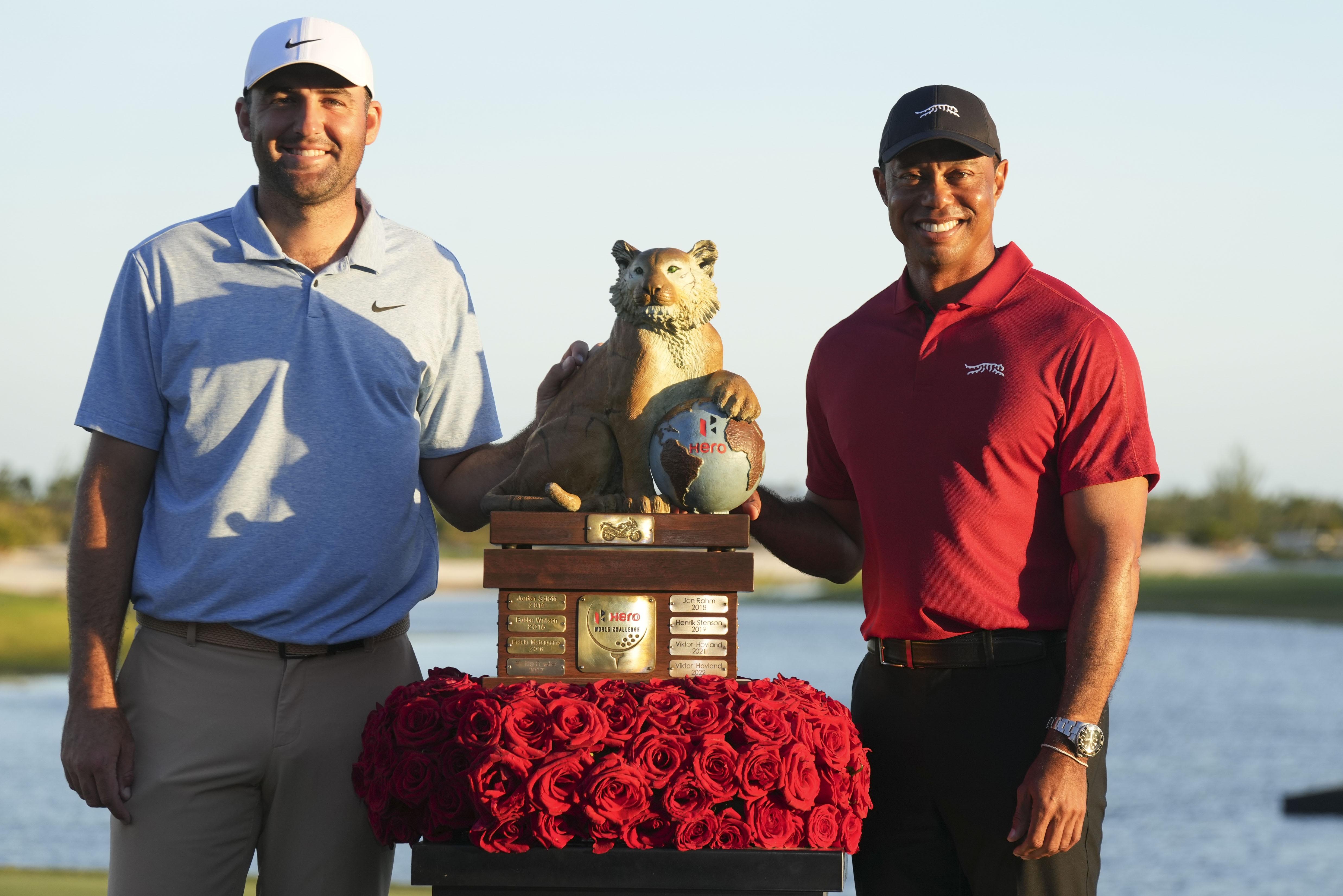 Scottie Scheffler, left, of the United States, and Tiger Woods, right, pose with the championship trophy after the final round of the Hero World Challenge PGA Tour at the Albany Golf Club in New Providence, Bahamas, Sunday, Dec. 8, 2024.