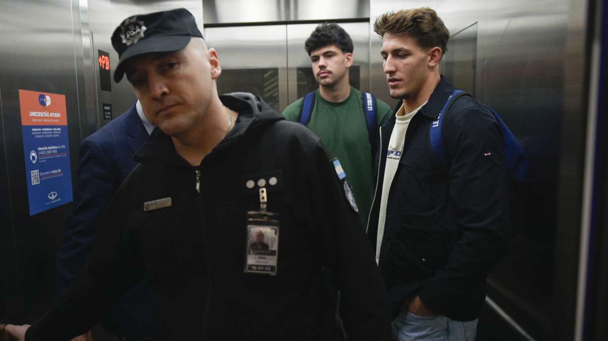 FILE - French rugby players Oscar Jegou, right, and Hugo Auradou, center, stand inside an elevator at the airport in Buenos Aires, Argentina, Sept. 3, 2024, after prosecutors decided to let the player leave the country despite remaining under investigation for alleged rape.