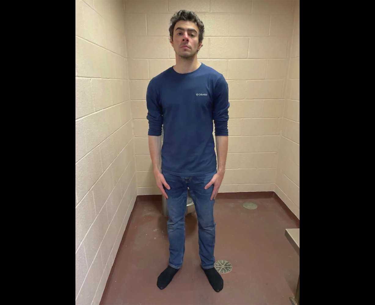 This photo shows Luigi Mangione, a suspect in the fatal shooting of UnitedHealthcare CEO Brian Thompson, at the police station in Altoona, Pa., on Monday.