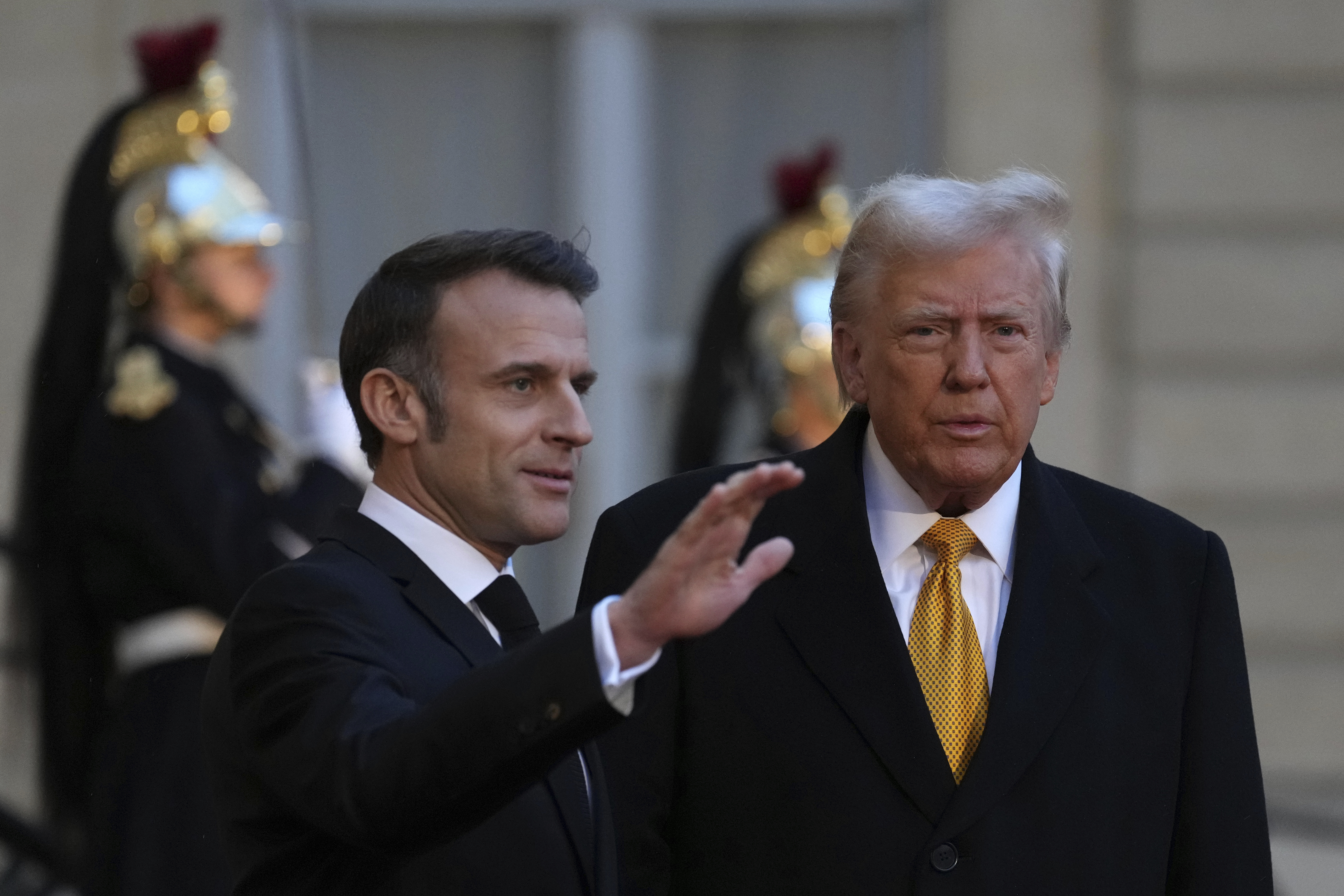 French President Emmanuel Macron welcomes U.S. President-elect Donald Trump at the Elysee Palace on Dec. 7 in Paris. Prosecutors are urging a judge not to throw out Trump's hush money criminal conviction.
