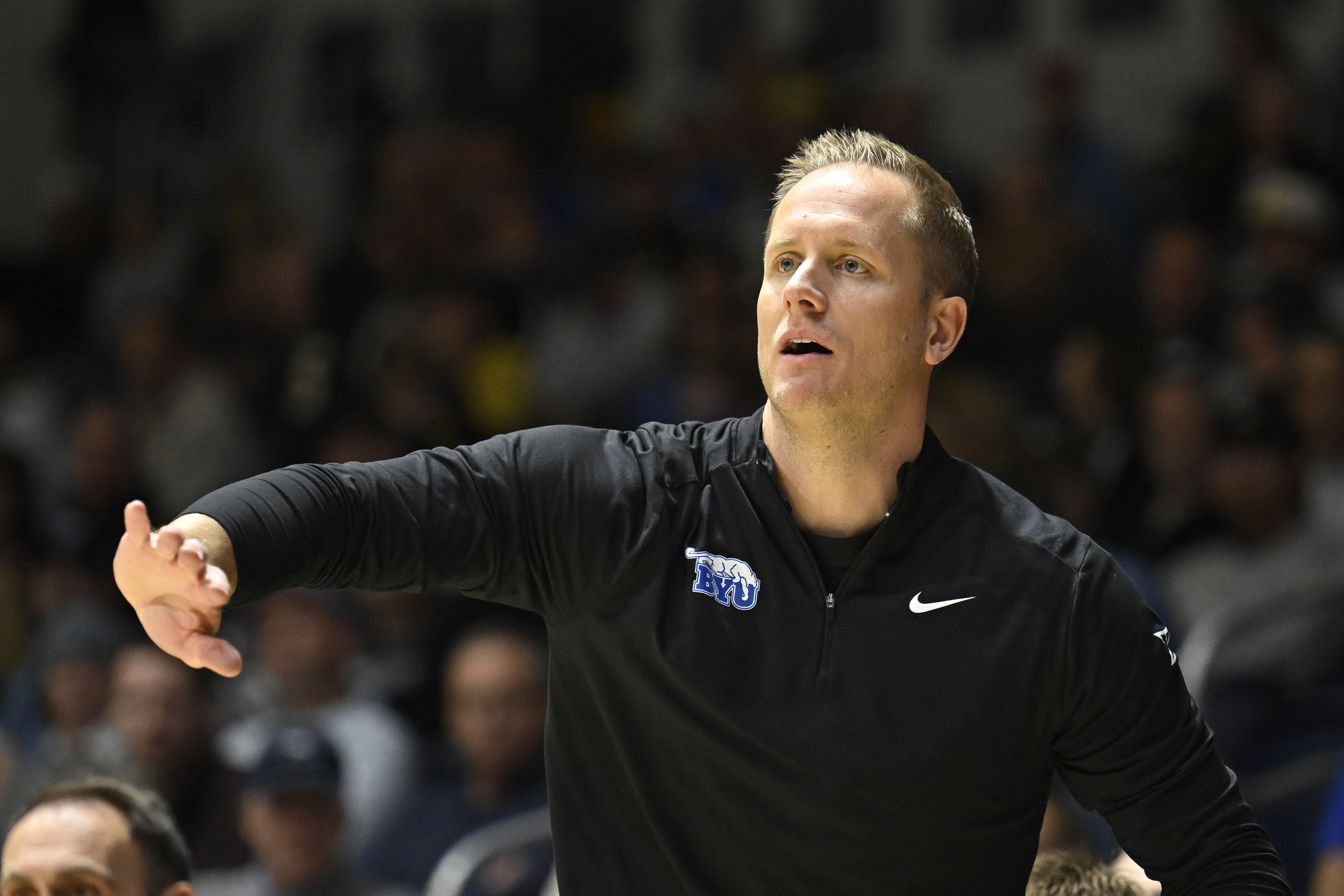 BYU head coach Kevin Young gestures from the sideline during the first half of an NCAA college basketball game against North Carolina State, Friday, Nov. 29, 2024, in San Diego.