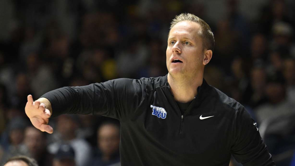 BYU head coach Kevin Young gestures from the sideline during the first half of an NCAA college basketball game against North Carolina State, Friday, Nov. 29, 2024, in San Diego.