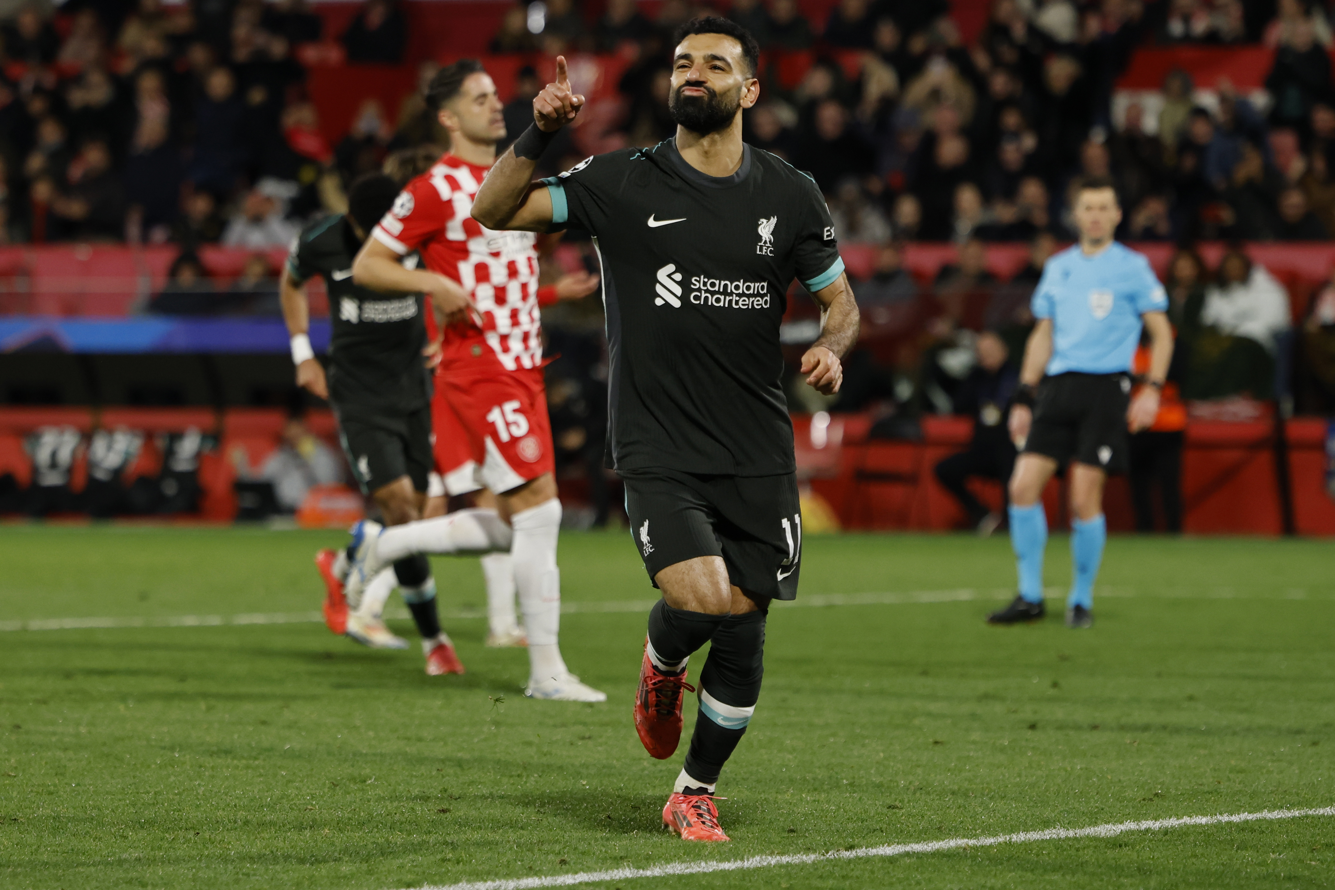 Liverpool's Mohamed Salah celebrates after scoring the opening goal during the Champions League soccer match between Girona and Liverpool at the Estadi Montilivi in Girona, Spain, Tuesday, Dec. 10, 2024.