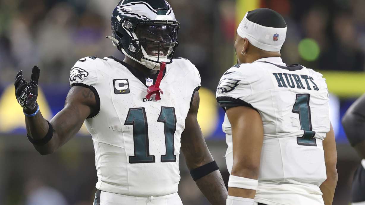 Philadelphia Eagles wide receiver A.J. Brown (11) celebrates with quarterback Jalen Hurts (1) during the second half of an NFL football game against the Los Angeles Rams in Inglewood, Calif., Sunday, Nov. 24, 2024.