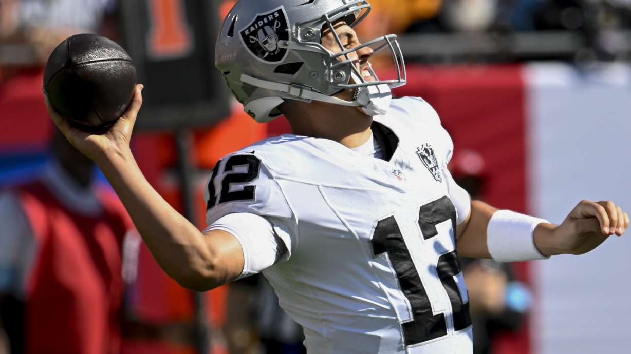 Las Vegas Raiders quarterback Aidan O'Connell (12) passes the ball against the Tampa Bay Buccaneers during the first half of an NFL football game, Sunday, Dec. 8, 2024, in Tampa, Fla.