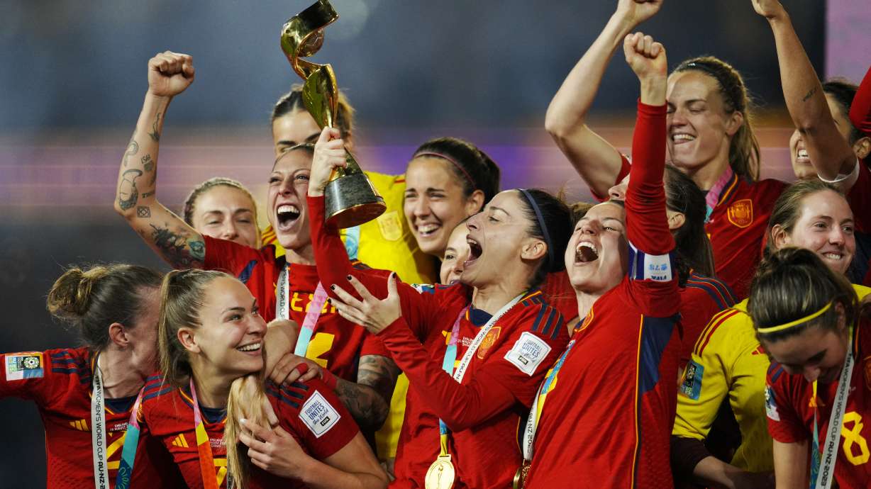 FILE - Spain's Esther Gonzalez holds the trophy and celebrates with teammate at the end of the Women's World Cup soccer final between Spain and England at Stadium Australia in Sydney, Australia, Sunday, Aug. 20, 2023.