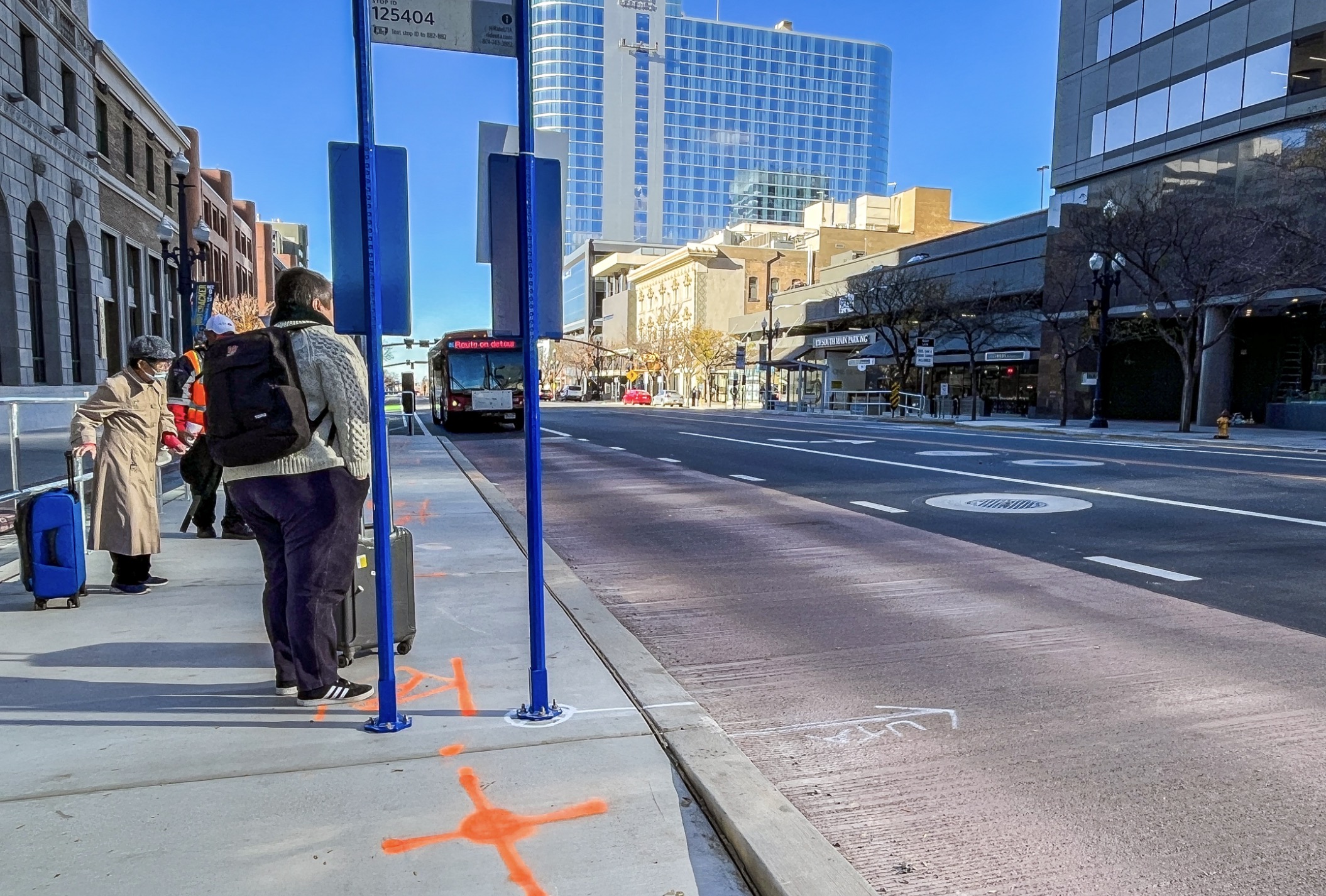 People wait at a 200 South bus stop in downtown Salt Lake City as a Utah Transit Authority bus arrives Tuesday morning. 200 South serves as the busiest bus corridor in the state.