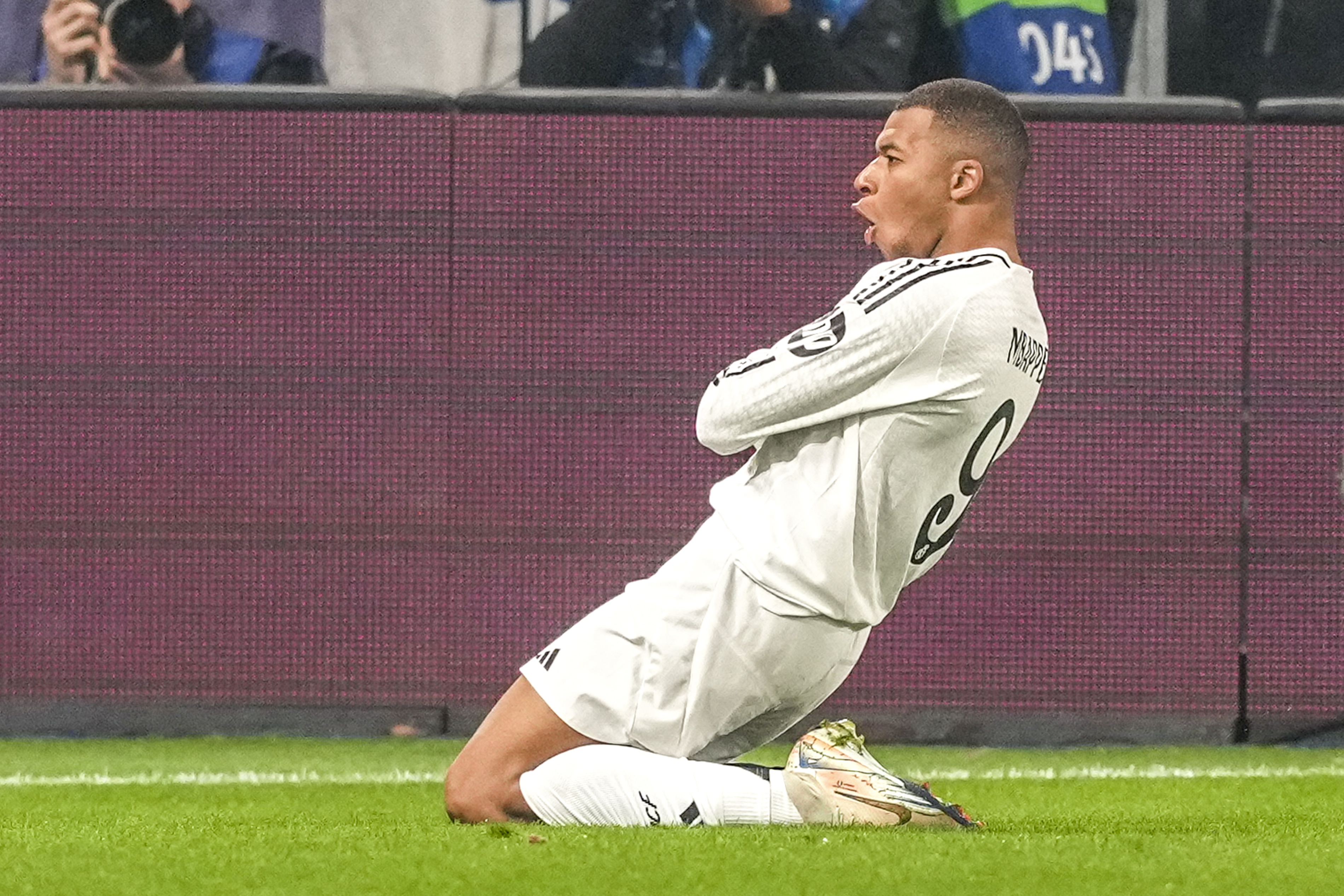 Real Madrid's Kylian Mbappe celebrates after he scored his side's first goal during the Champions League opening phase soccer match between Atalanta and Real Madrid at the Bergamo's stadium, in Bergamo, Italy, Tuesday, Dec. 10, 2024.