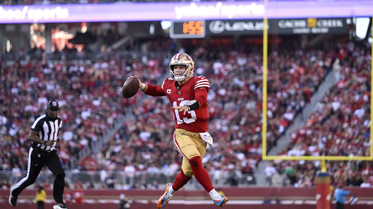 San Francisco 49ers quarterback Brock Purdy (13) rolls out to pass against the Chicago Bears during the first half of an NFL football game in Santa Clara, Calif., Sunday, Dec. 8, 2024.