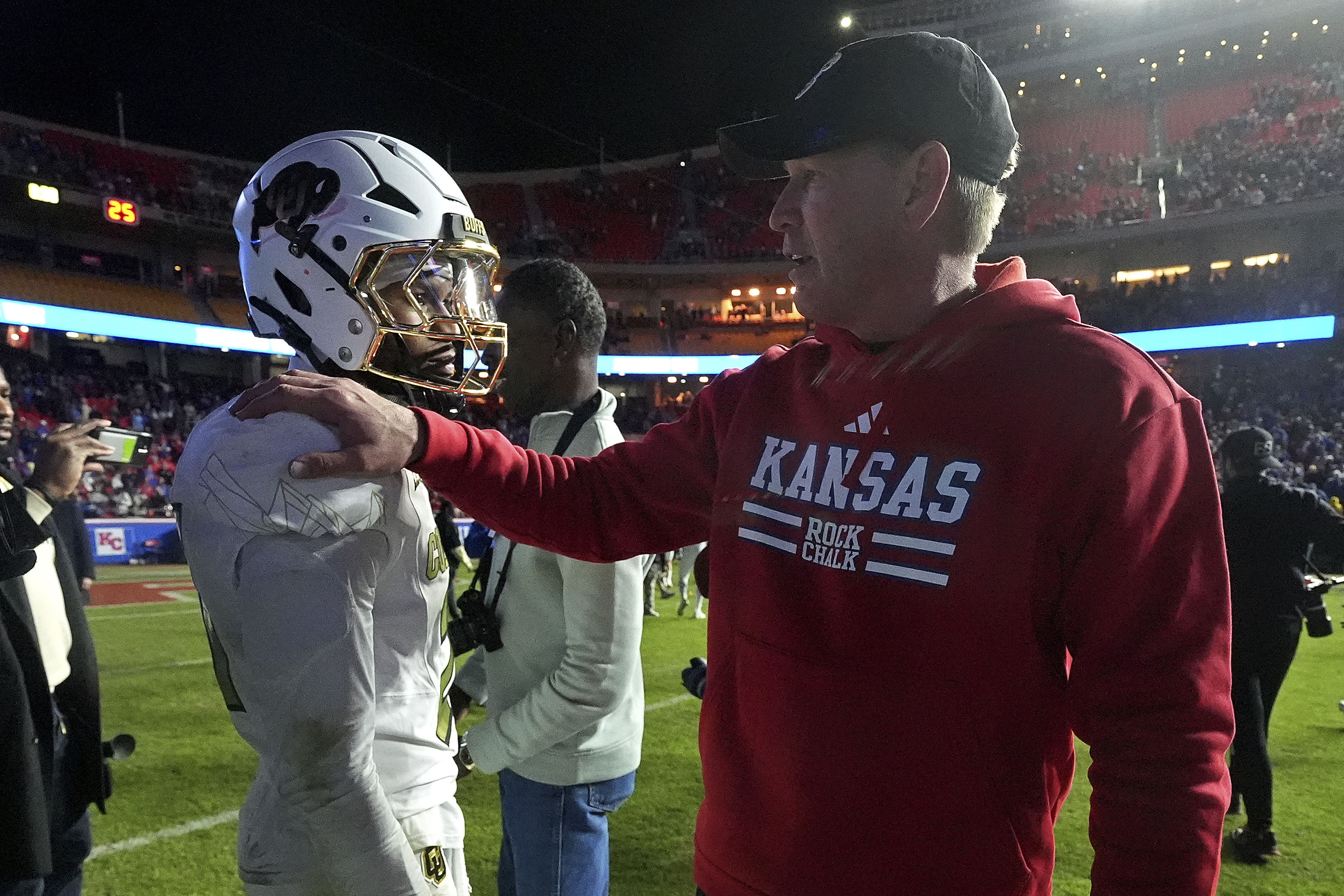 Kansas head coach Lance Leipold talks to Colorado safety Shilo Sanders after their NCAA college football game, Saturday, Nov. 23, 2024, in Kansas City, Mo.