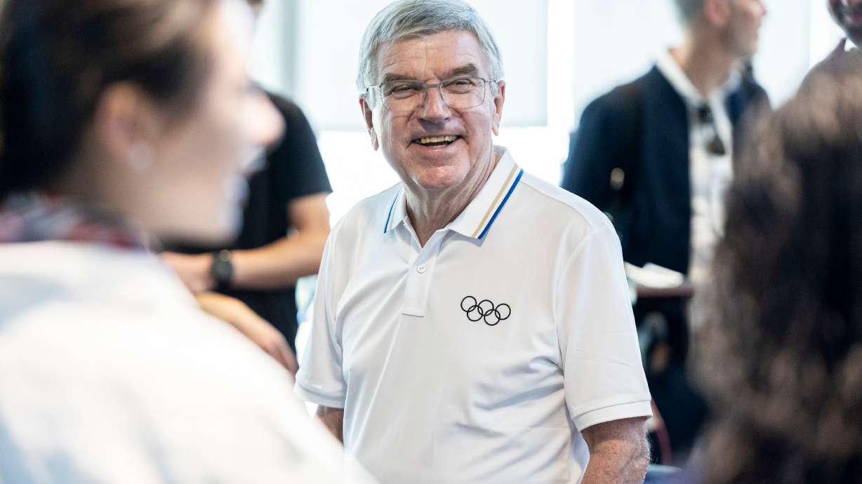 International Olympic Committee President Thomas Bach talks with athletes as he and others from his delegation tour the U.S. Speedskating Speed Factory Training Center at the Utah Olympic Oval in Kearns on Sept. 28.