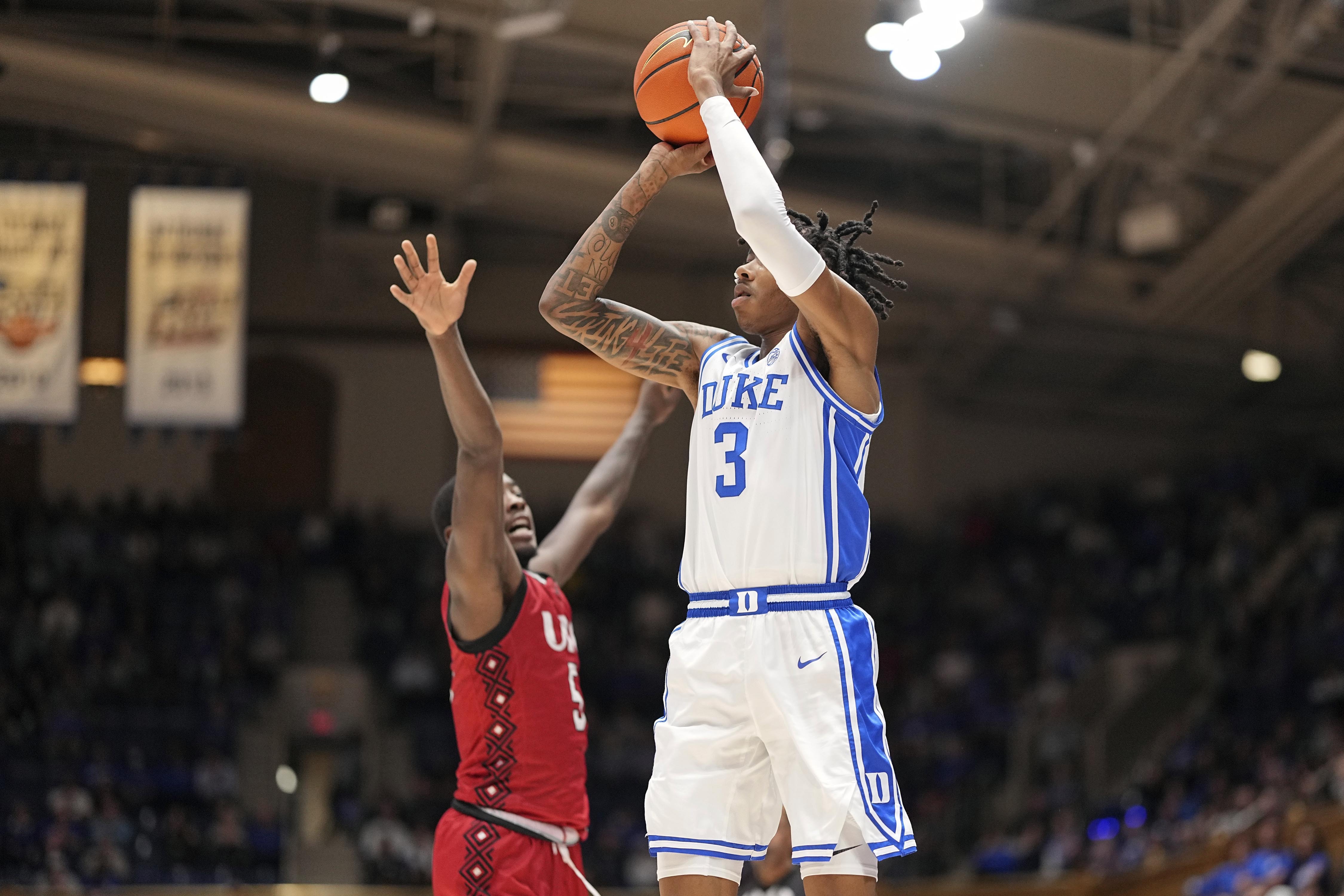 Duke guard Isaiah Evans (3) makes a three-point basket over Incarnate Word guard Davion Bailey (5) during the second half of an NCAA college basketball game on Tuesday, Dec. 10, 2024, in Durham, N.C.