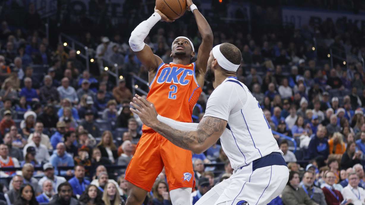Oklahoma City Thunder guard Shai Gilgeous-Alexander (2) shoots against Dallas Mavericks center Daniel Gafford, right, during the first half of an Emirates NBA Cup basketball game, Tuesday, Dec. 10, 2024, in Oklahoma City.