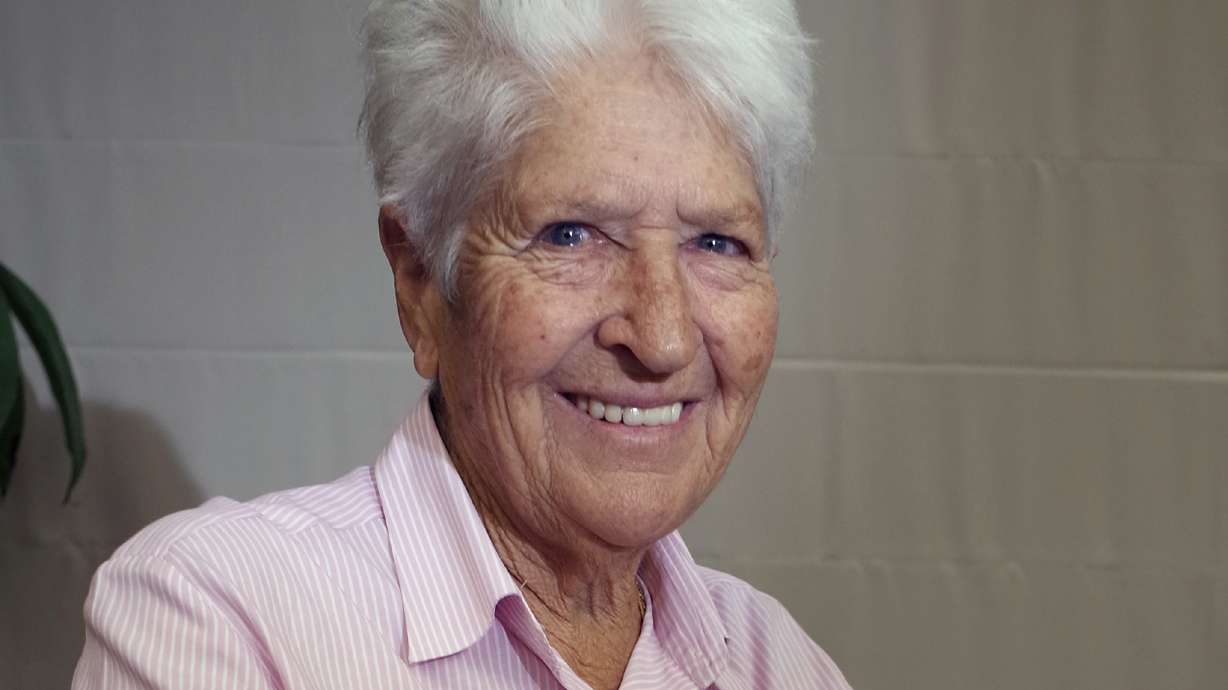 FILE - In this Oct. 9, 2014, file photo, Australian Olympic swimming great Dawn Fraser smiles during an interview in Tokyo.