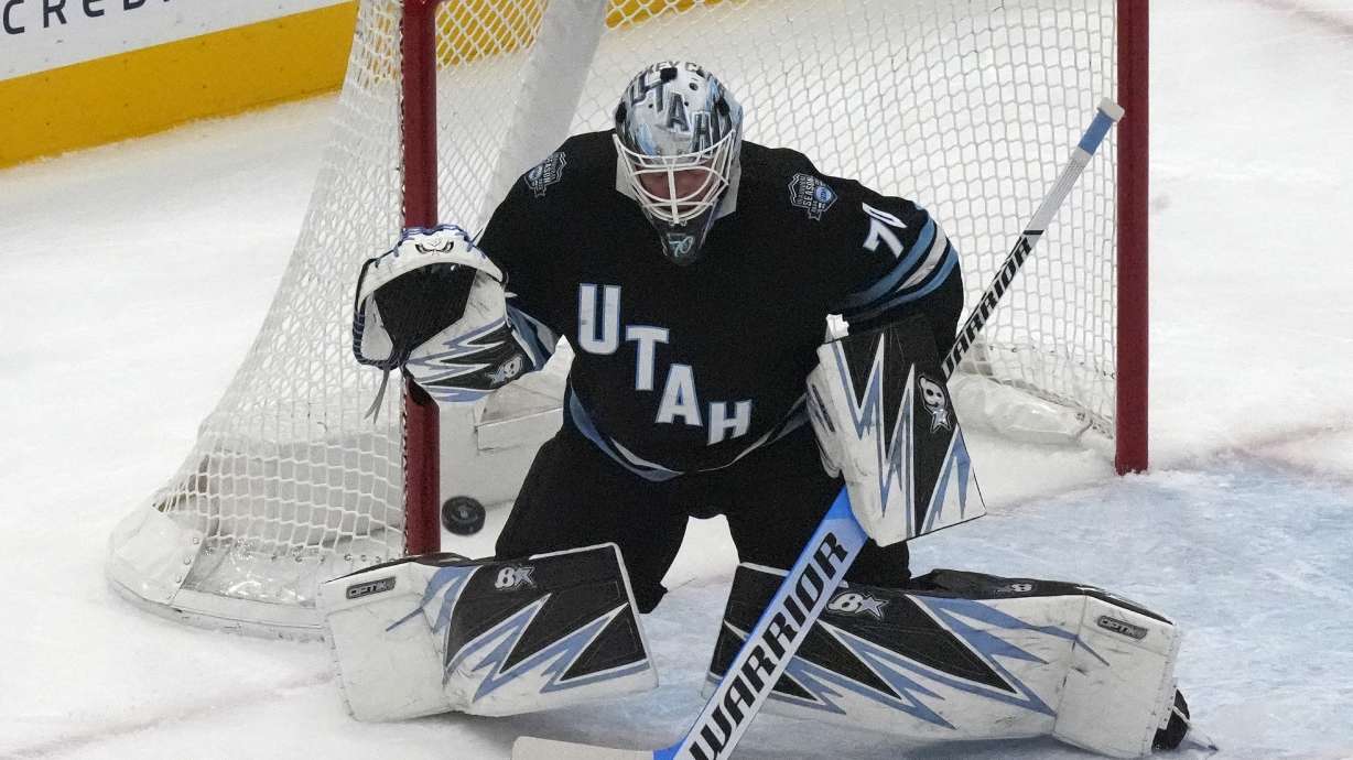 Utah Hockey Club goaltender Karel Vejmelka (70) makes a save against the Minnesota Wild during the first period of an NHL hockey game Tuesday, Dec. 10, 2024, in Salt Lake City.